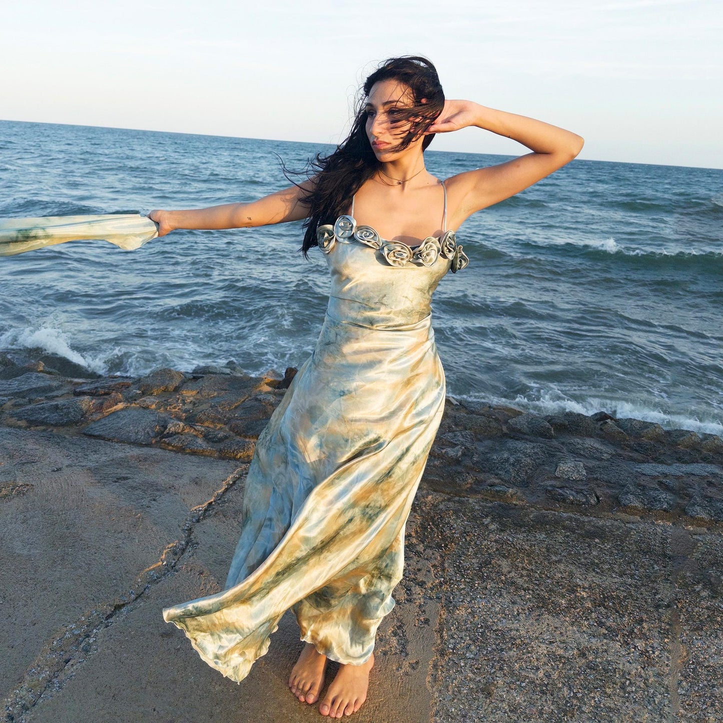 The vintage 2000s pastel tie-dye slip dress is a French-made fantasy in soft blues, greens, and gold. With sculptural rosette appliqué along the bust and a matching scarf, it moves like light on water. The shiny satin-style finish and fluid midi length evoke fairytale softness—ideal for proms, weddings, or summer nights. A romantic Y2K archive crafted from a shimmering non-stretch polyester blend. Great vintage condition.