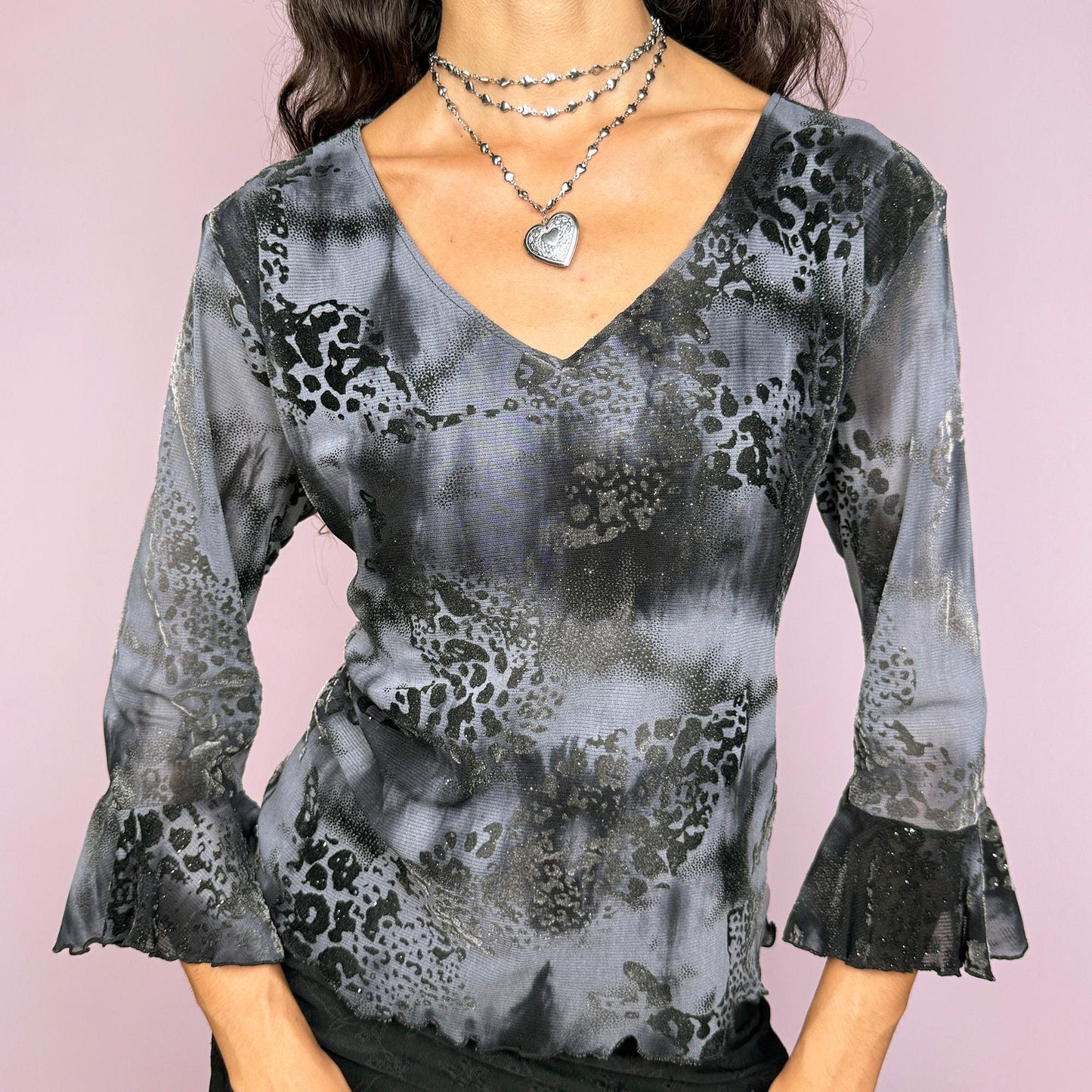 This vintage 2000s gray and black top features a tie-dye burnout velvet design on sheer mesh. Styled with three-quarter bell sleeves and a flattering V-neckline, it blends witchy elegance with gothic glam. A dramatic French-made piece, perfect for evening events, parties, or midnight styling. A rare Y2K archival find with unique texture and allure. Made from a stretchy polyester blend velvet mesh. Great vintage condition.