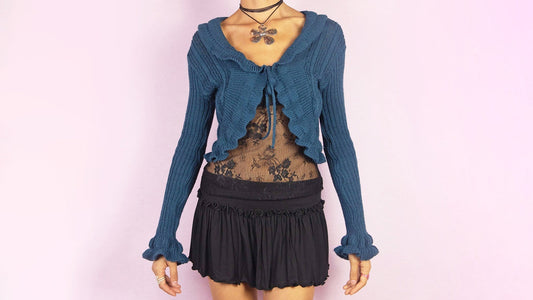 vintage y2k 2000s Navy blue knit bolero with ruffle trim, layered over sheer lace top.