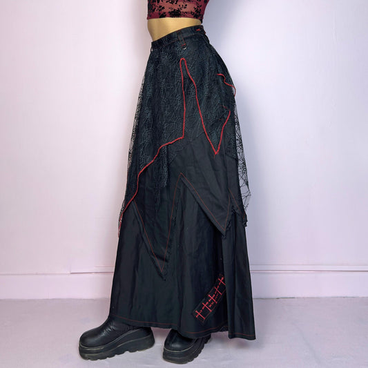 The Black Layered Maxi Skirt is a vintage edgy statement piece crafted by the Japanese punk fashion brand RIGHT? Anarchxism = Kexstation. It features a multi-layered design with mesh web-like overlays, bold red stitching details. Adult World Shop