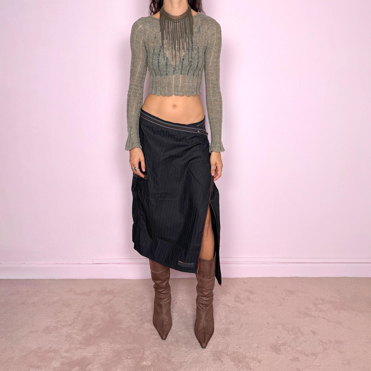 Vintage 2000s black midi skirt by French label Cop Copine, made from 100% cotton with no stretch. Features an asymmetric wrap-style construction, subtle vertical stripe texture, snap-button fastening at the waist, and a dramatic side slit with contrast topstitching. Finished with layered panel detailing for a deconstructed, utilitarian, dark avant-garde look. Can be worn mid-rise for size M or lower on the waist for size S. Excellent vintage condition.