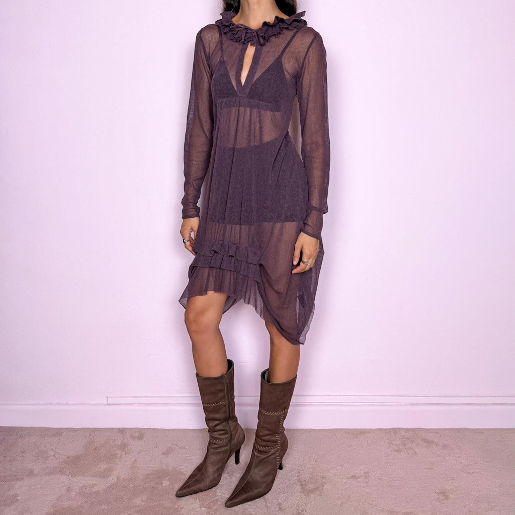 Vintage 2000s dark purple sheer dress by French label Cop Copine. Featuring a semi-sheer long-sleeve silhouette with a front tie detail at the neckline, layered ruffle trim and an asymmetric draped hem. Romantic avant-garde design for statement sheer styling and layered looks. Crafted from a stretchy 65% polyester and 35% cotton blend. Great vintage condition.