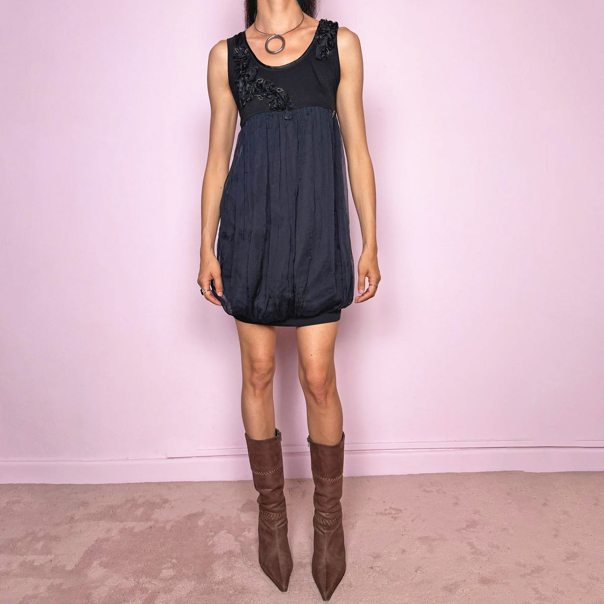 Vintage 2000s Galliano black bubble mini dress from John Galliano’s diffusion line, featuring a fitted stretchy cotton sleeveless bodice, floral appliqué details at the neckline, a voluminous crinkled semi-sheer viscose overlay, and a bubble hem silhouette. A dark romantic feminine designer piece, perfect for elevated evening looks. Excellent vintage condition overall, with a tiny hole and a small reddish mark on one side of the outer semi-sheer layer, as shown in the last picture.