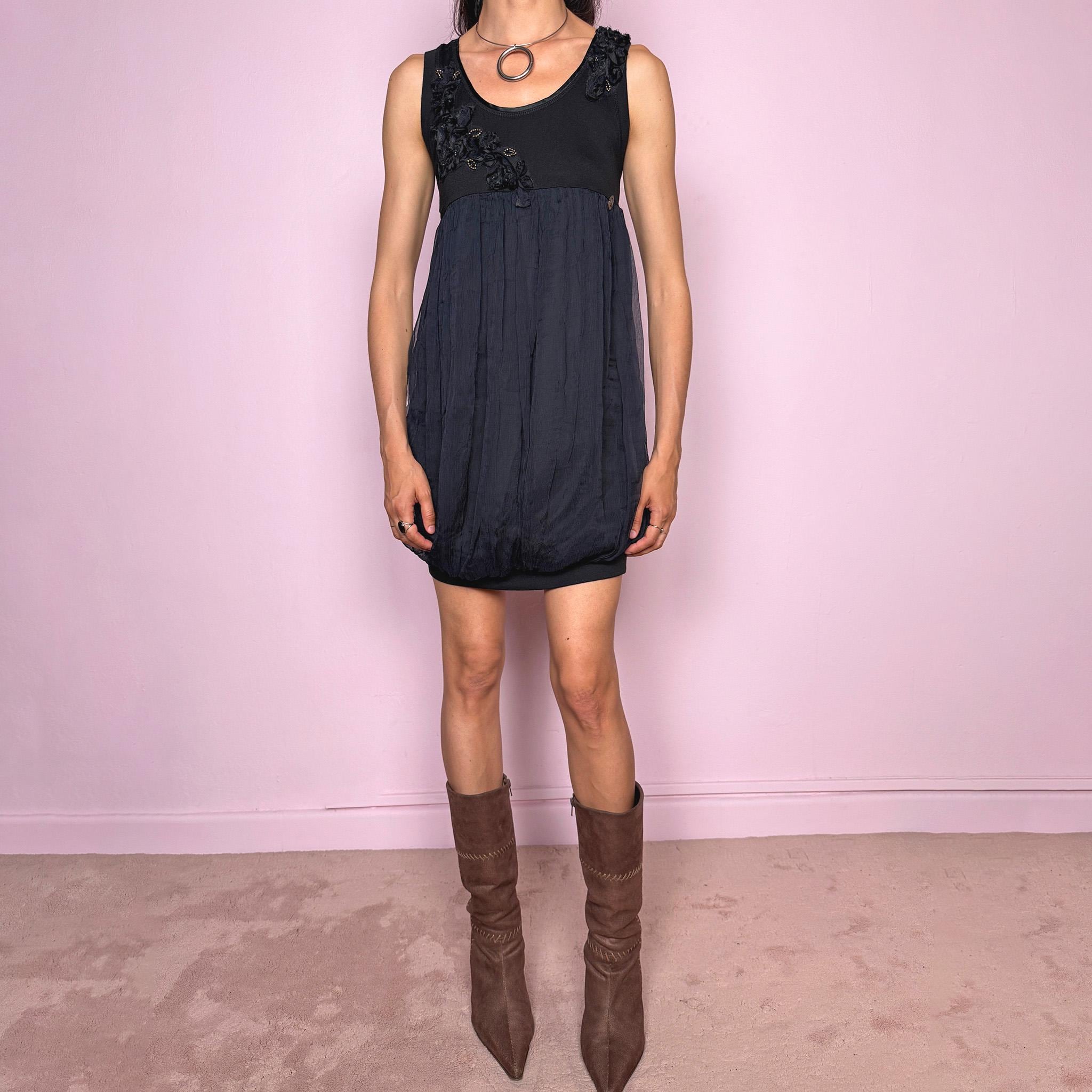 Vintage 2000s Galliano black bubble mini dress featuring a fitted stretchy cotton sleeveless bodice, floral appliqué details at the neckline, a voluminous crinkled semi-sheer viscose overlay, and a bubble hem silhouette. Beautiful late 90s / early 2000s dark romantic, slightly gothic, and very feminine aesthetic, perfect for elevated evening looks.