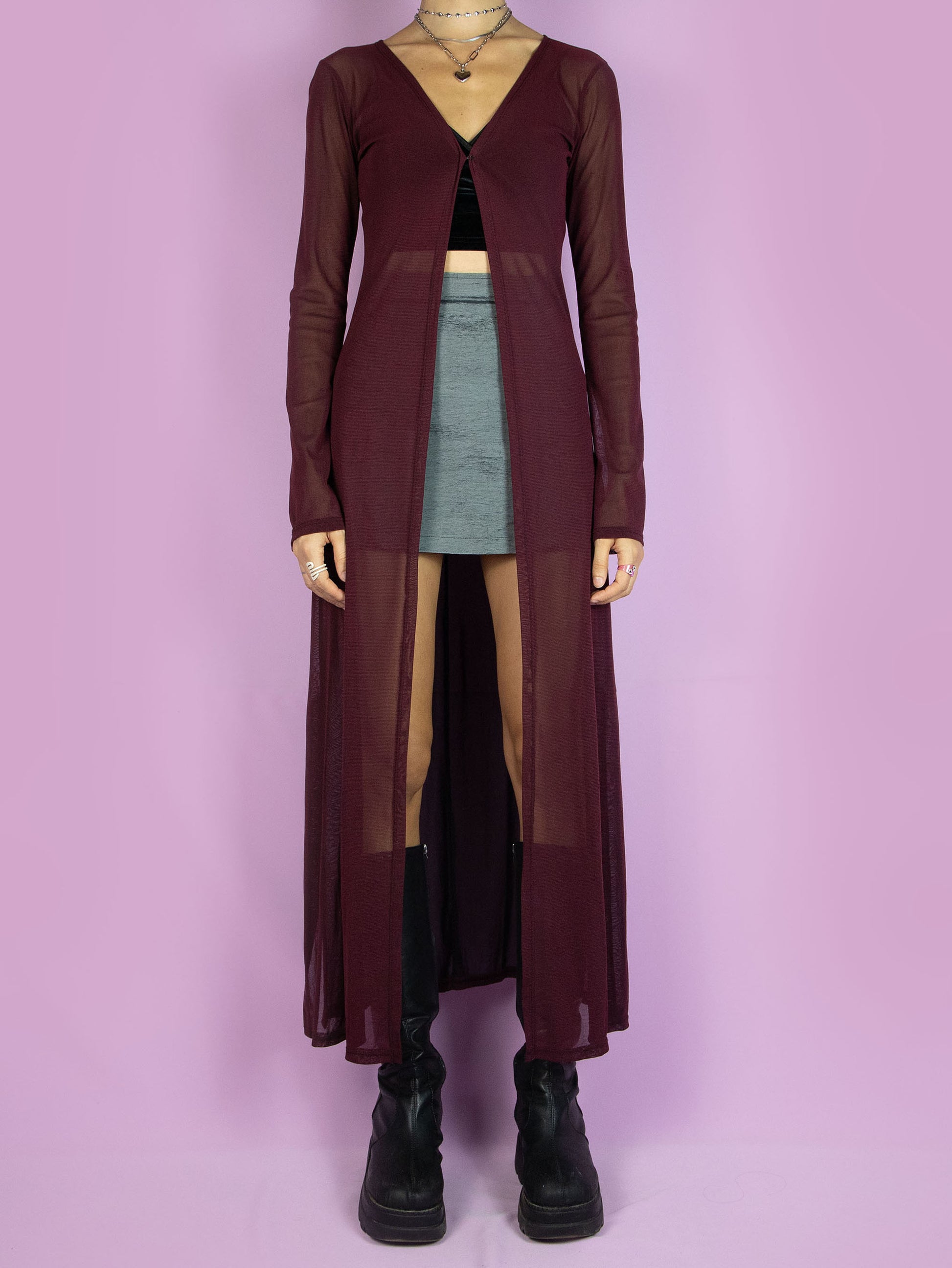 The Y2K Maroon Mesh Duster Jacket is a vintage 2000s cyber festival rave party style burgundy semi-sheer maxi long coat with bell sleeves and a front hook closure.
