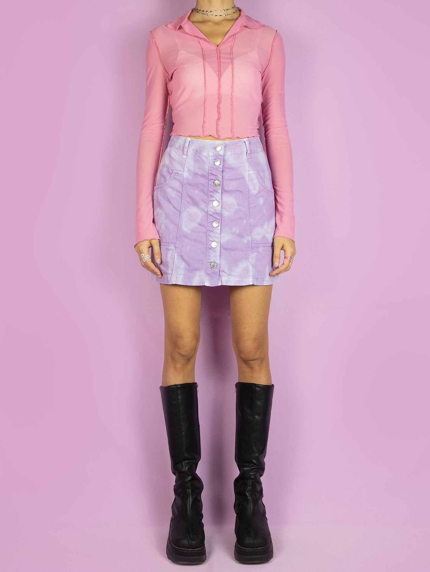 The Y2K Tie Dye Mini Skirt is a vintage 2000s summer festival style pastel purple lilac and blue bleached denim a-line skirt with pockets and buttons.
