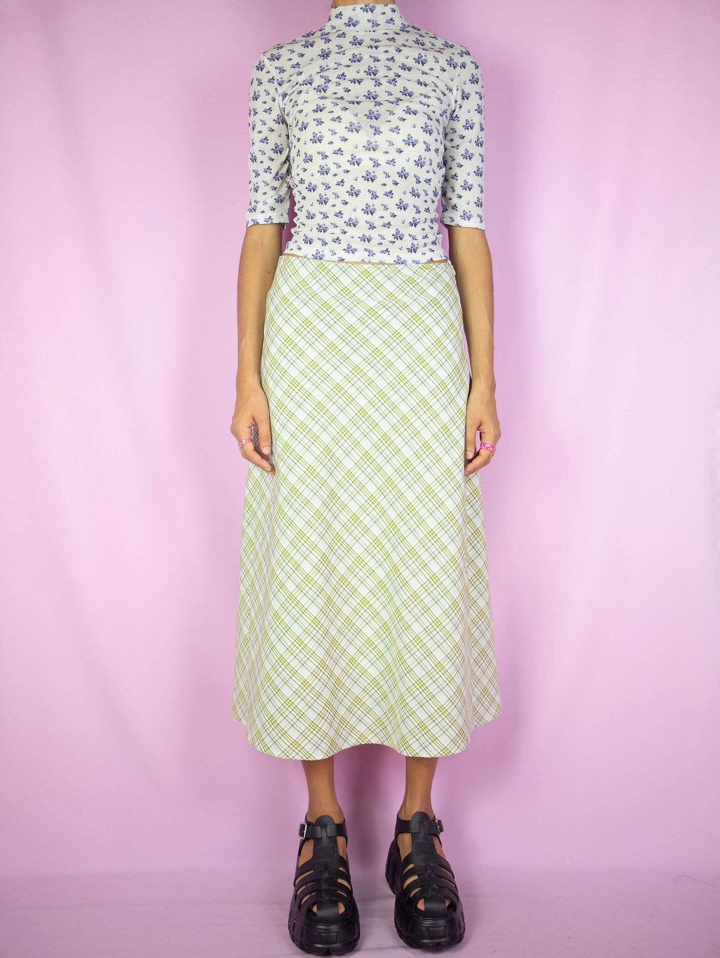 The Y2K Plaid Print Midi Skirt is a vintage 2000s boho preppy inspired beige, yellow and green checkered maxi skirt with side zipper closure.