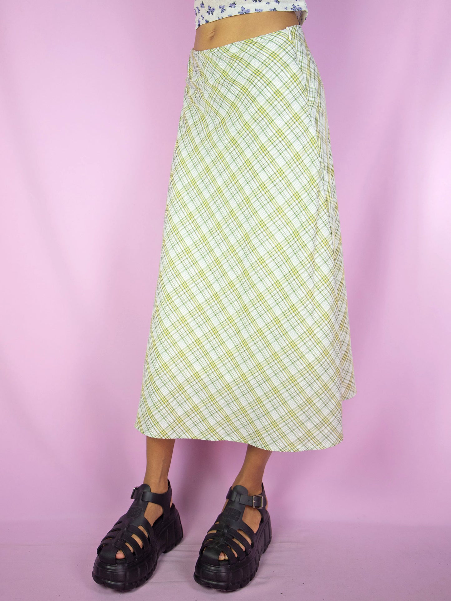 The Y2K Plaid Print Midi Skirt is a vintage 2000s boho preppy inspired beige, yellow and green checkered maxi skirt with side zipper closure.