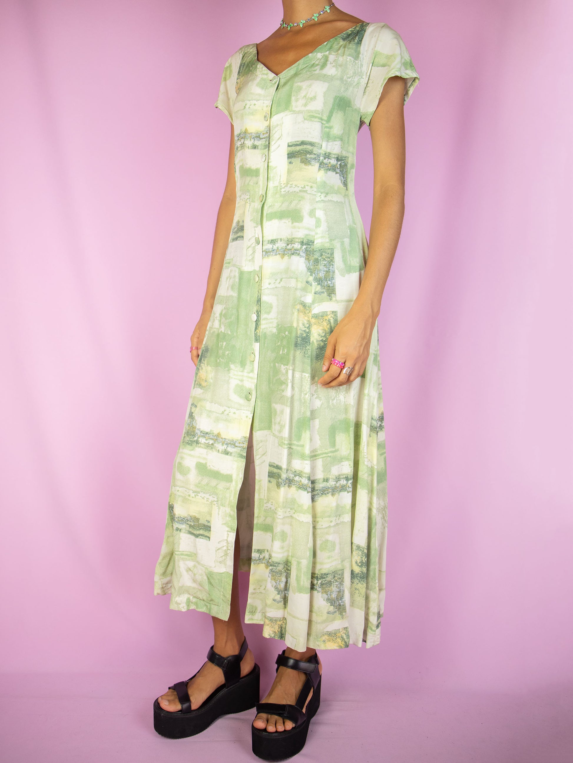 The Vintage 90s Boho Abstract Midi Dress is a green and white abstract short sleeve button down flared dress. Retro summer 1990s graphic maxi dress.