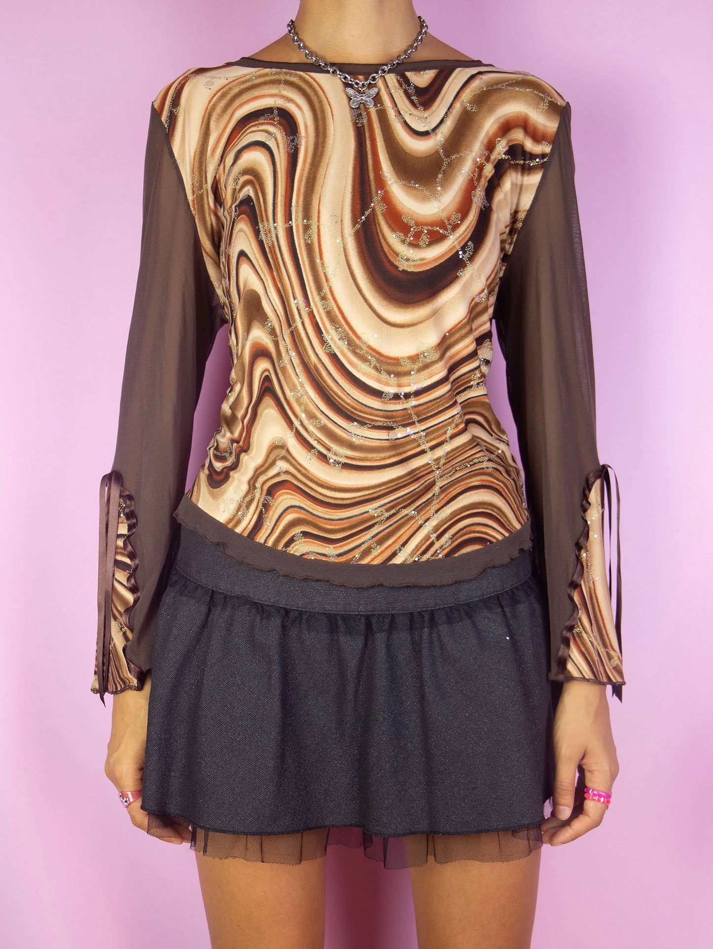 The Y2K Brown Print Mesh Top is a vintage 2000s festival party style semi-sheer bell sleeve abstract swirl graphic shirt embellished with sparkle glitter details. Made in Spain.