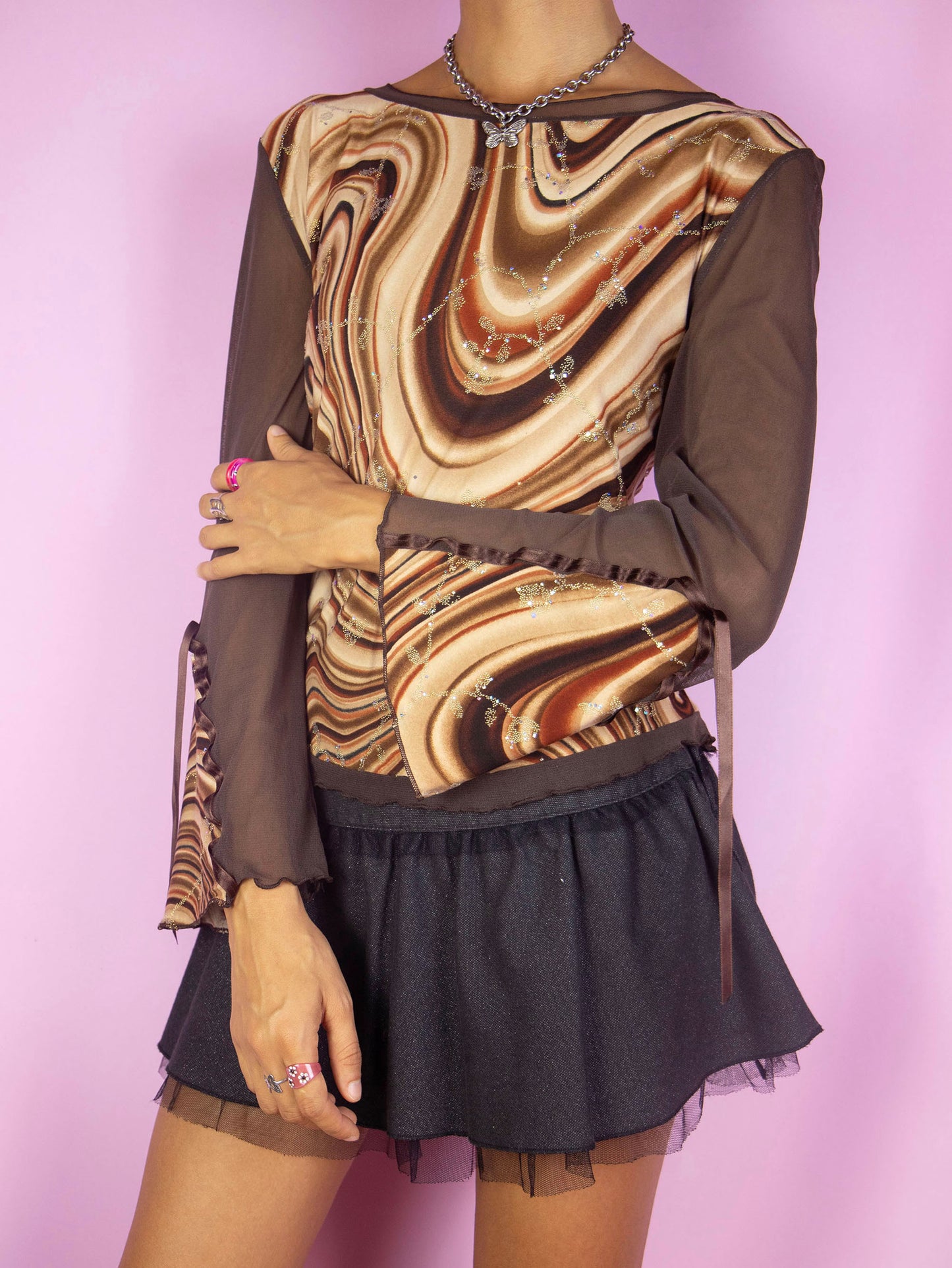 The Y2K Brown Print Mesh Top is a vintage 2000s festival party style semi-sheer bell sleeve abstract swirl graphic shirt embellished with sparkle glitter details. Made in Spain.