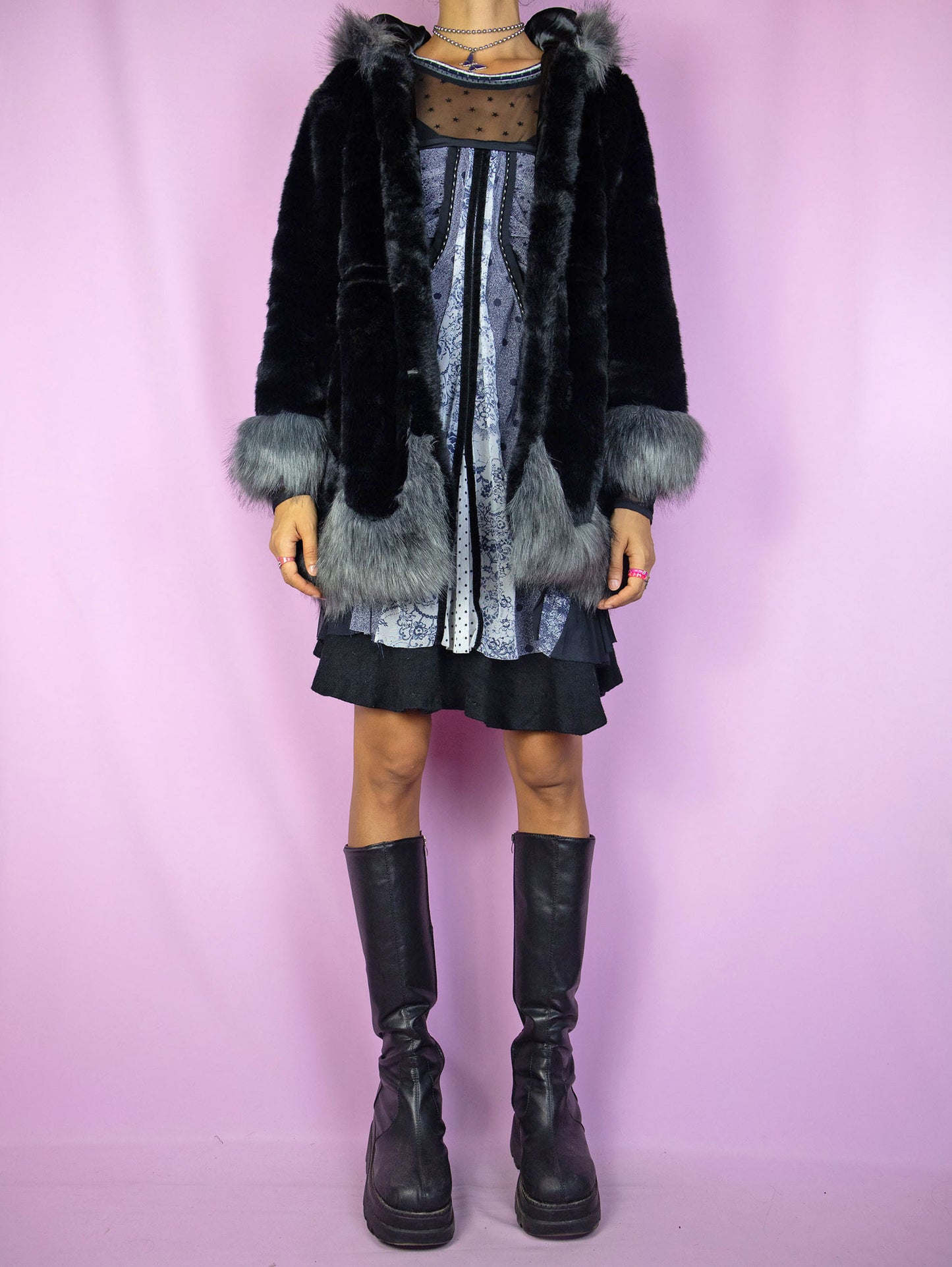 The Y2K Black Faux Fur Jacket is a vintage black faux fur jacket with gray details, a hood, pockets, and hook closure. A cute dark fairy goth winter statement coat from the 2000s.