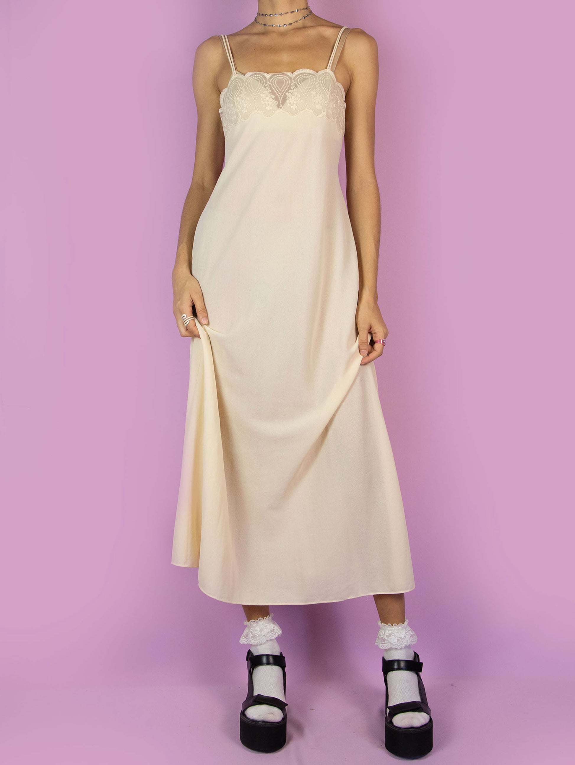 The Vintage 90s Beige Slip Maxi Dress is a romantic light beige-cream semi-sheer midi cami night dress with double straps and lace detail at the front.
