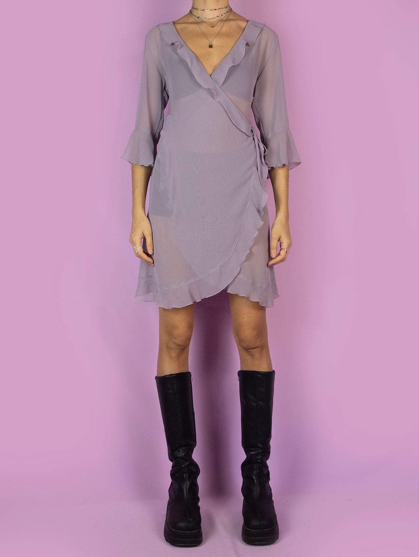 The Y2K Purple Sheer Duster Robe is a vintage dusty purple semi-transparent robe with ruffles, wrapped and tied at the side. Romantic coquette 2000s peignoir jacket.