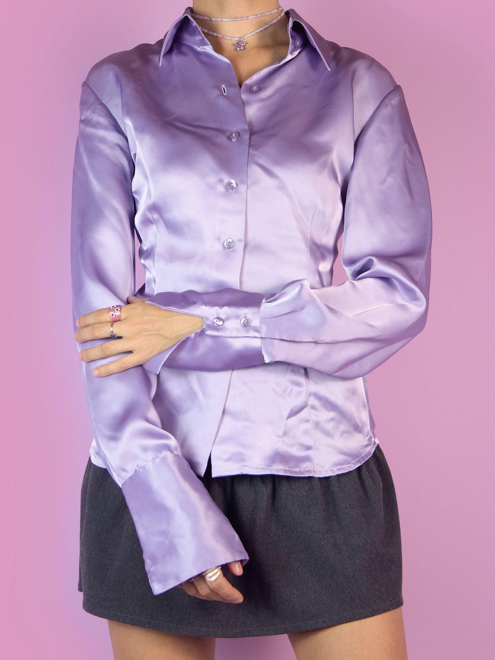 The Y2K Purple Satin Blouse is a fitted shirt with a collar and buttons. Elegant preppy 2000s office work blouse.