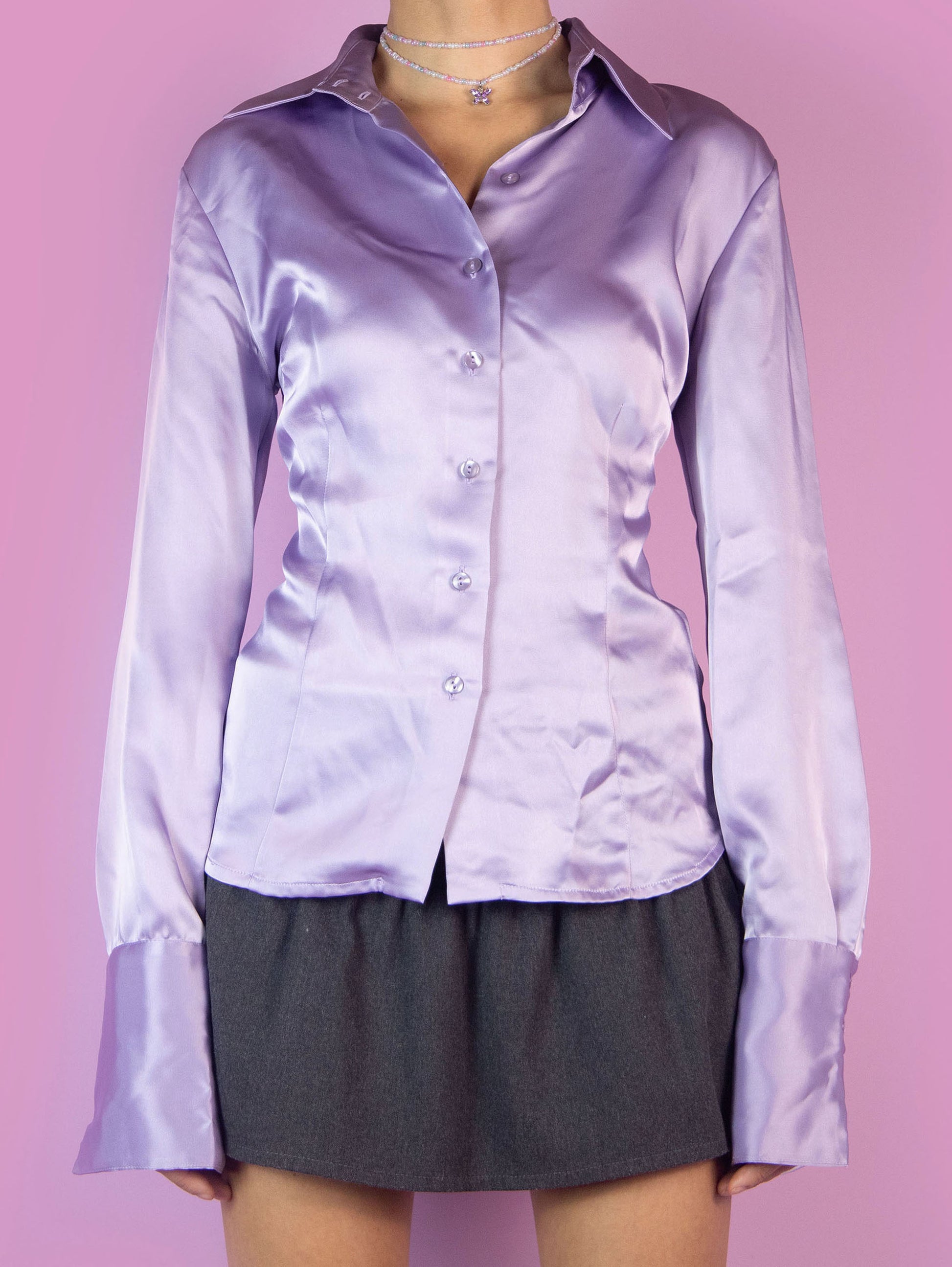 The Y2K Purple Satin Blouse is a fitted shirt with a collar and buttons. Elegant preppy 2000s office work blouse.