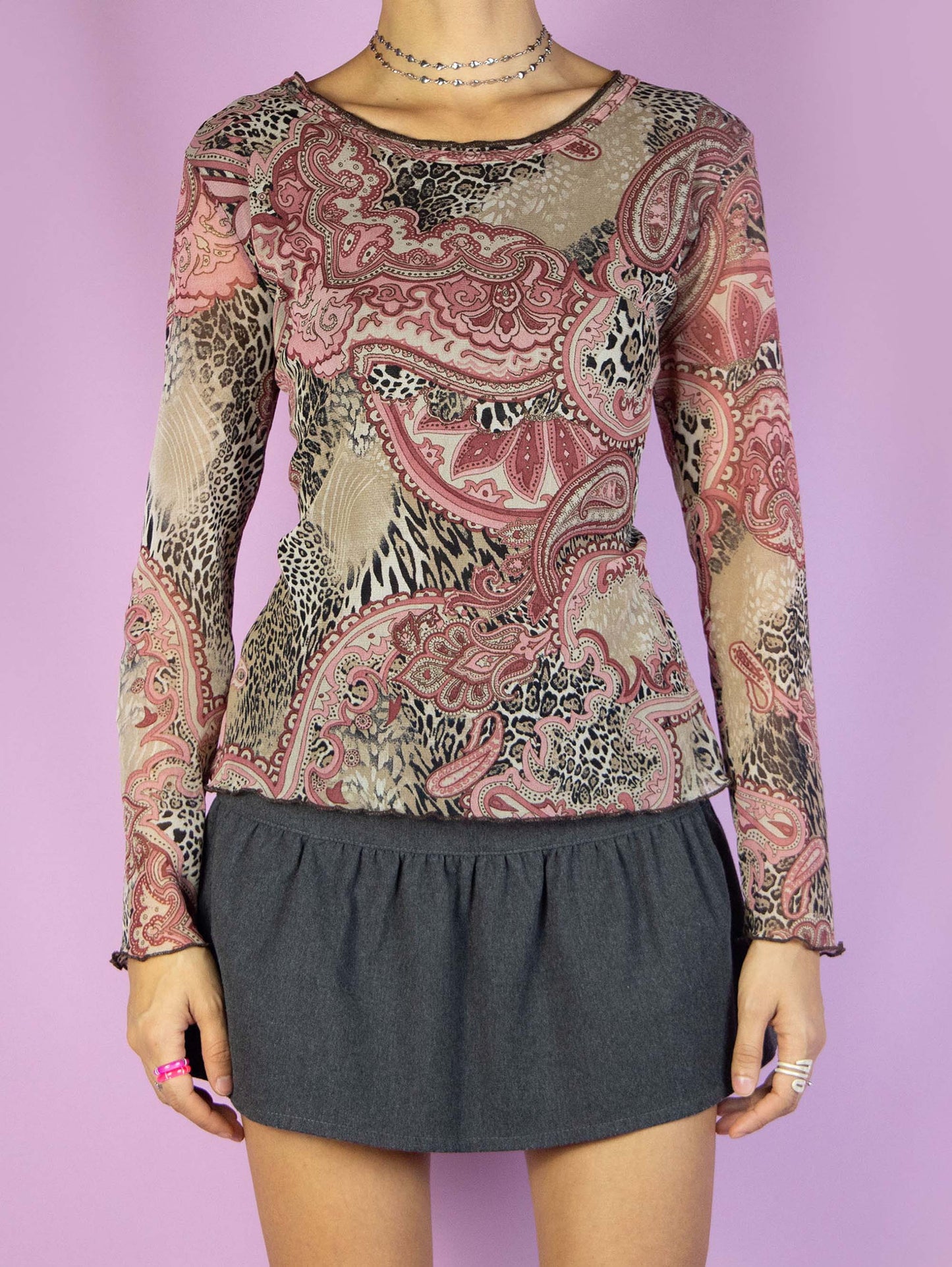 The Y2K Paisley Printed Mesh Top is a vintage 2000s boho-inspired long-sleeved, semi-sheer shirt. It features a multicolored abstract floral and animal print pattern. Perfect for casual everyday outfits.