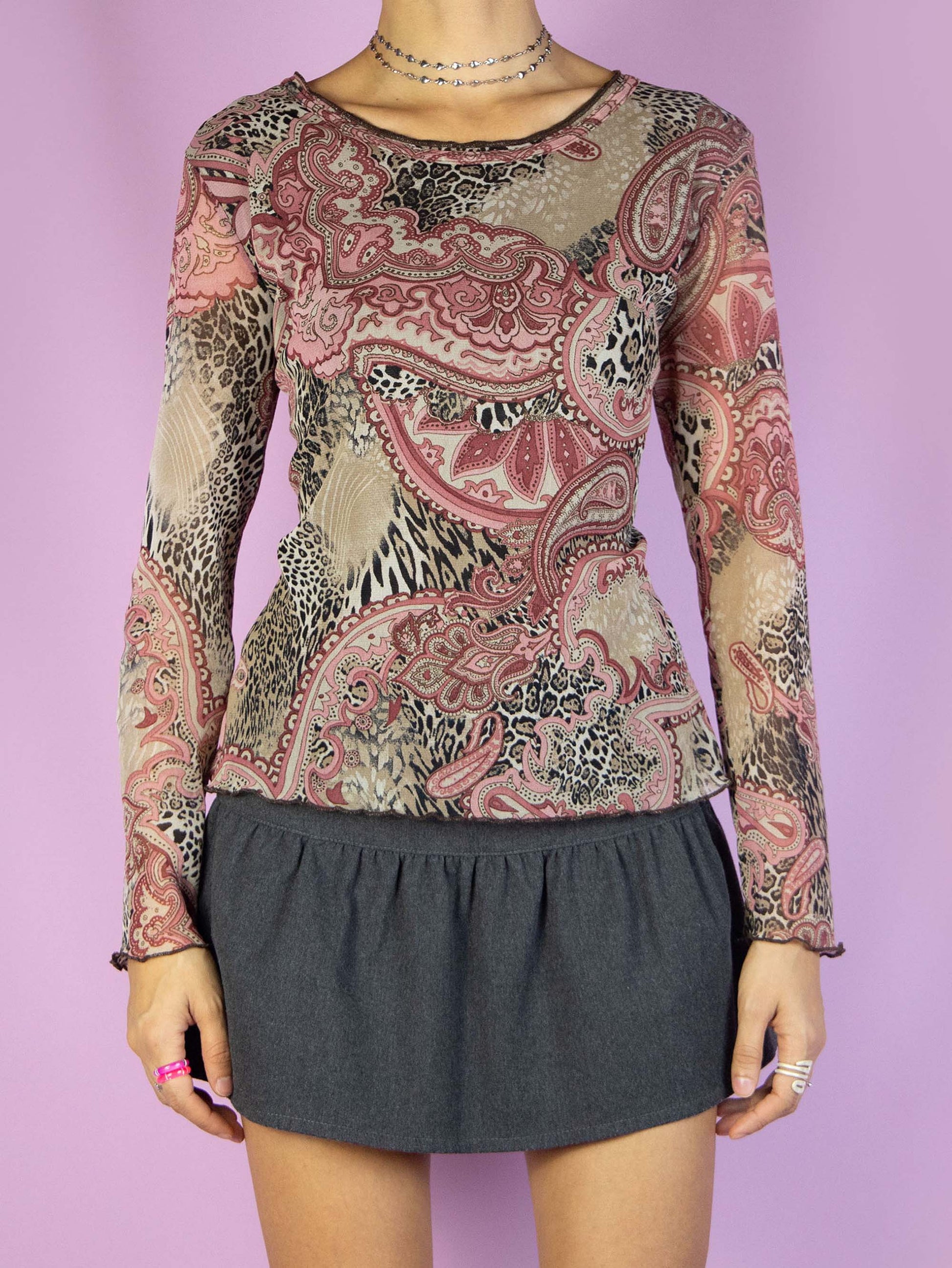 The Y2K Paisley Printed Mesh Top is a vintage 2000s boho-inspired long-sleeved, semi-sheer shirt. It features a multicolored abstract floral and animal print pattern. Perfect for casual everyday outfits.