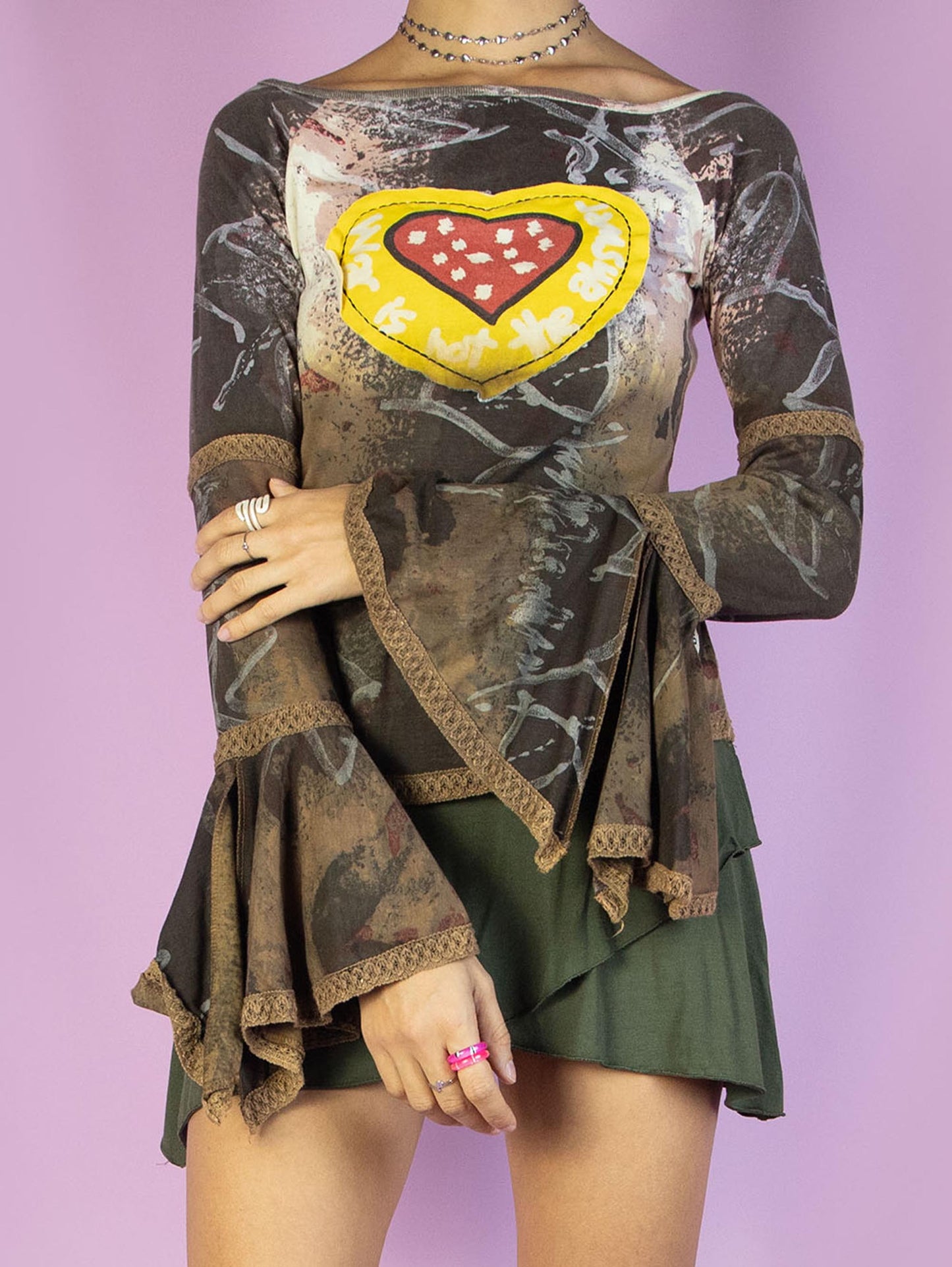 The Y2K Desigual Brown Bell Sleeve Top is a multicolored graphic brown shirt with an abstract print, long bell sleeves, and a heart-shaped patchwork-style detail. Cyber avant garde 2000s subversive top.
