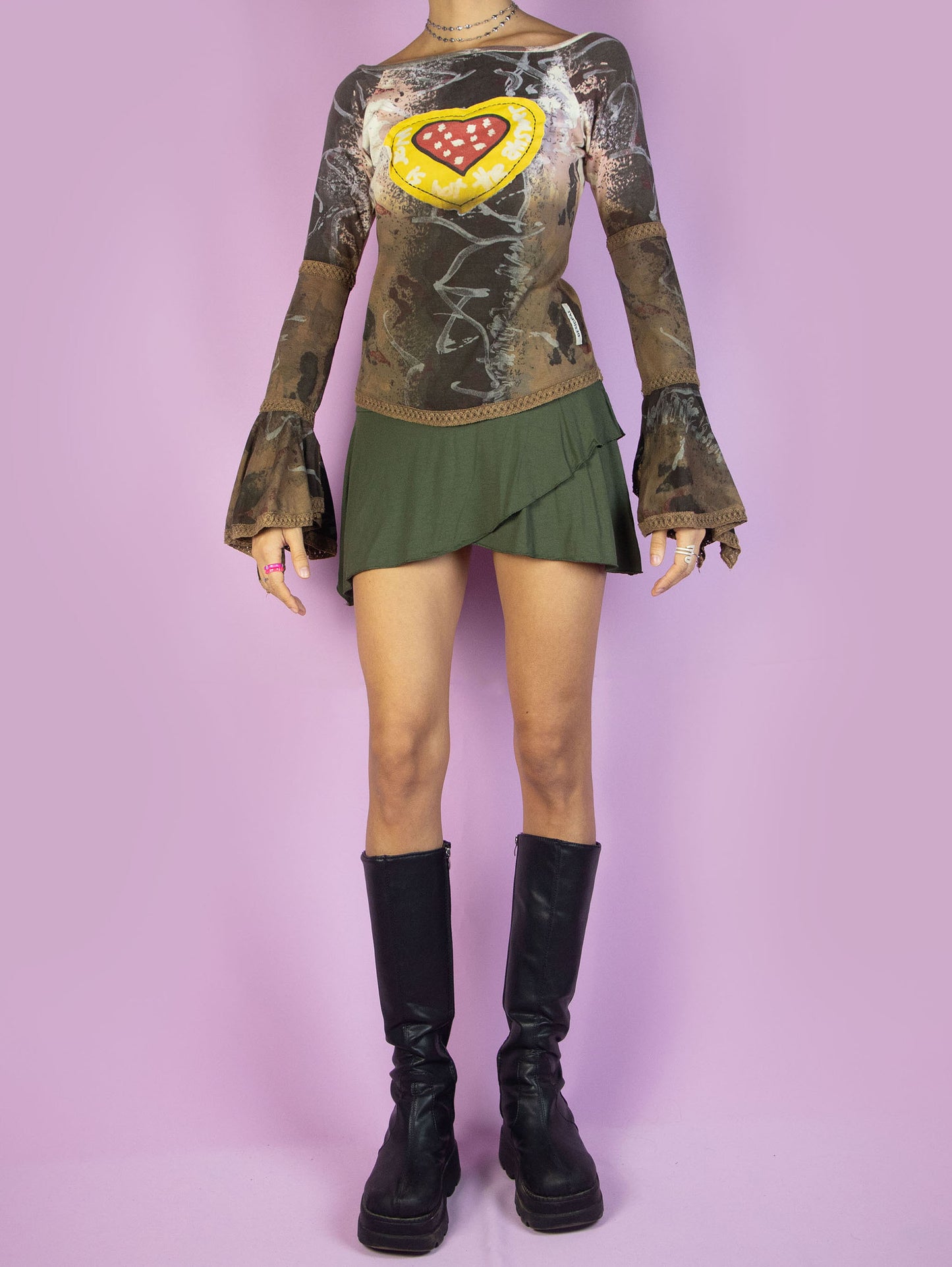 The Y2K Desigual Brown Bell Sleeve Top is a multicolored graphic brown shirt with an abstract print, long bell sleeves, and a heart-shaped patchwork-style detail. Cyber avant garde 2000s subversive top.
