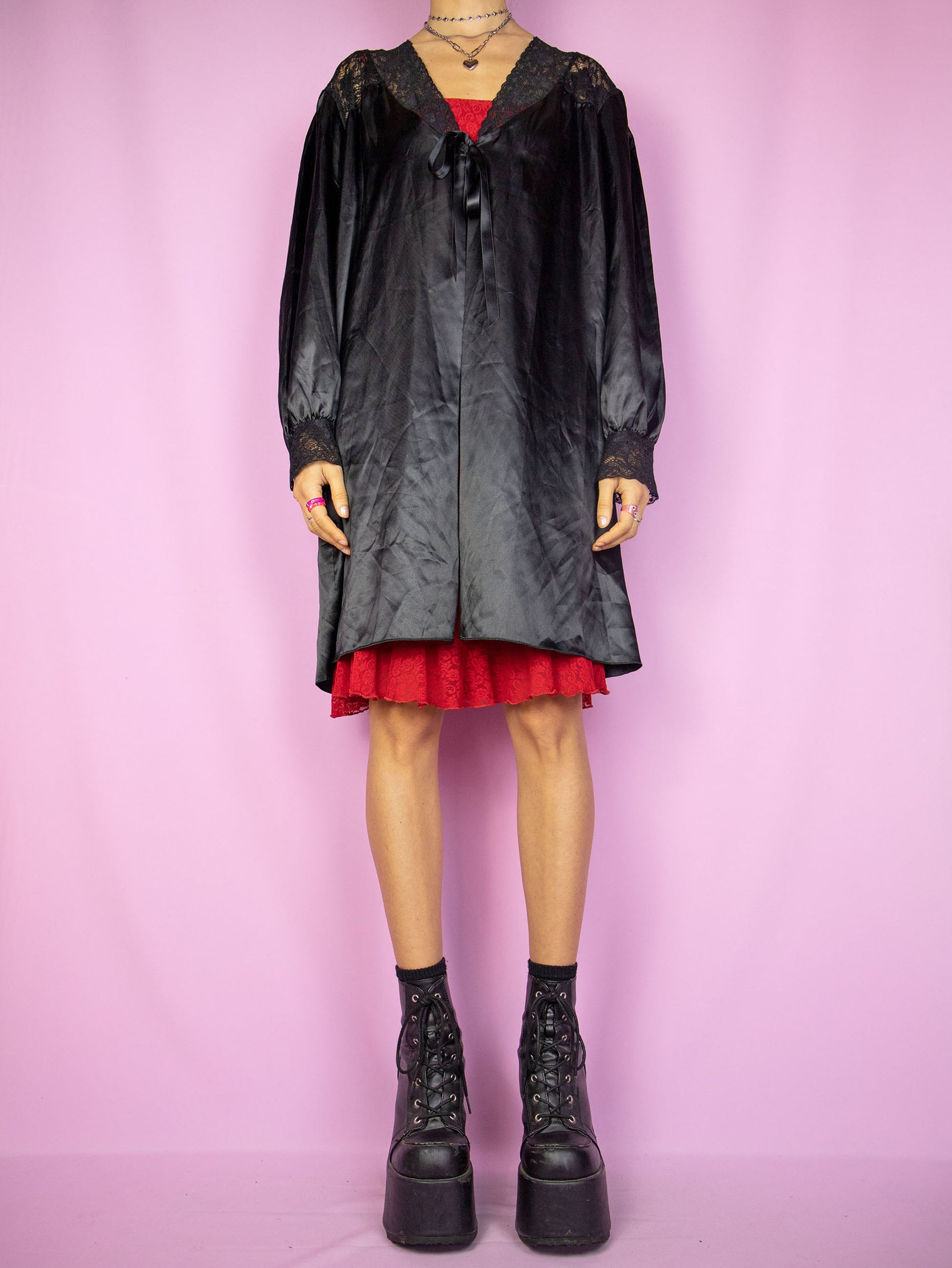 The Vintage 90s Black Satin Duster Jacket is a shiny balloon sleeve tie-front robe peignoir lounge sleepwear with lace details. Made in Spain.