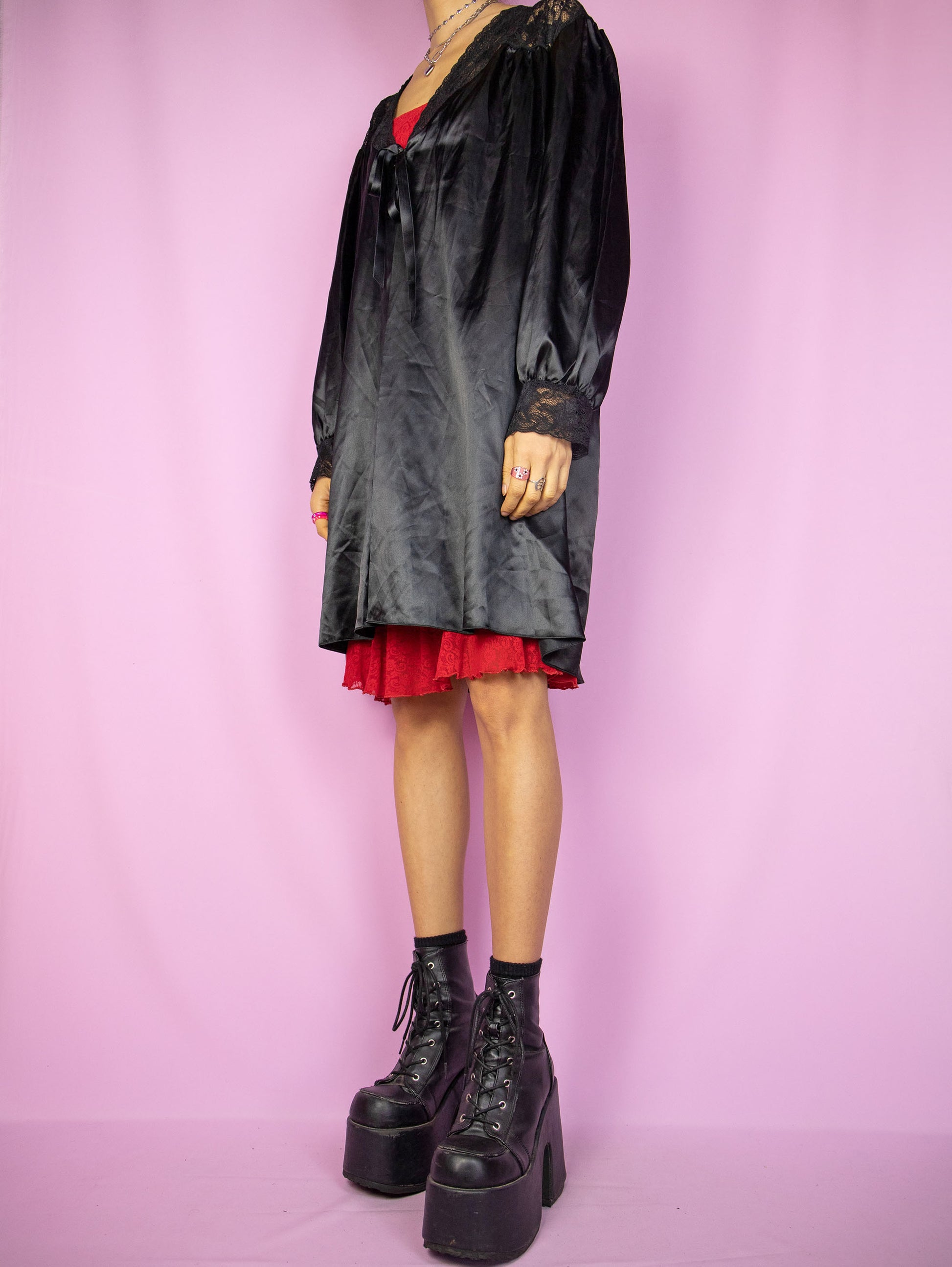The Vintage 90s Black Satin Duster Jacket is a shiny balloon sleeve tie-front robe peignoir lounge sleepwear with lace details. Made in Spain.