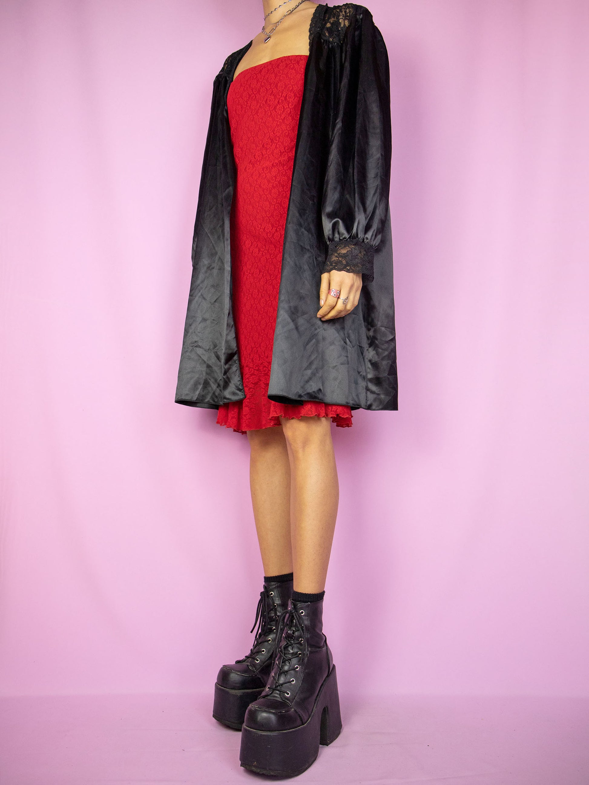 The Vintage 90s Black Satin Duster Jacket is a shiny balloon sleeve tie-front robe peignoir lounge sleepwear with lace details. Made in Spain.