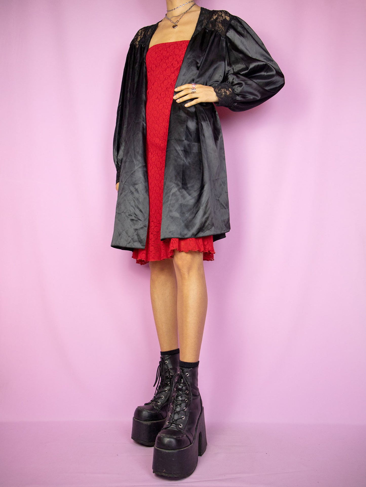 The Vintage 90s Black Satin Duster Jacket is a shiny balloon sleeve tie-front robe peignoir lounge sleepwear with lace details. Made in Spain.
