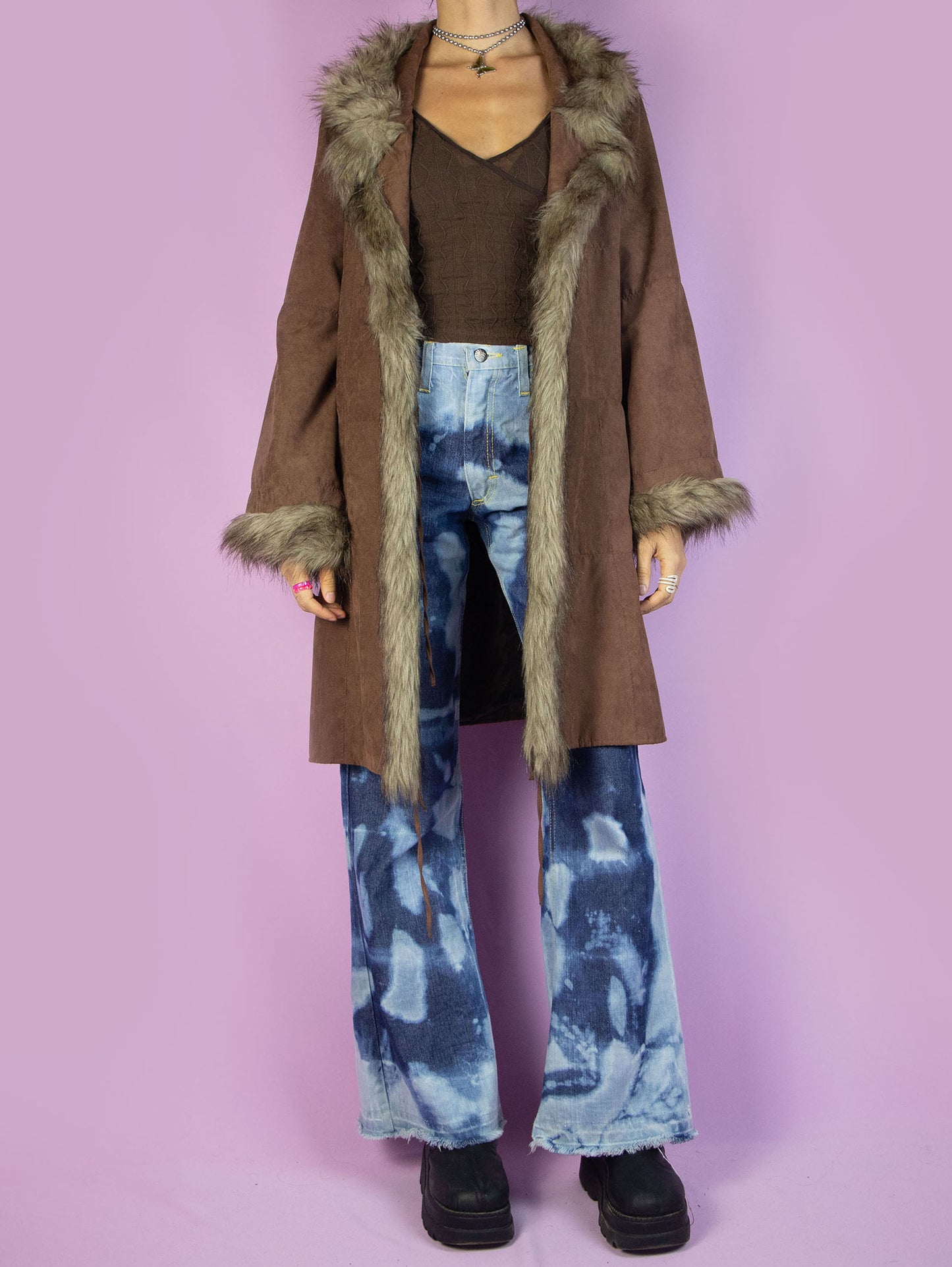 The Y2K Brown Penny Lane Coat is a vintage 2000s afghan-inspired faux suede statement jacket with faux fur collar and cuffs, featuring pockets and a tied front.