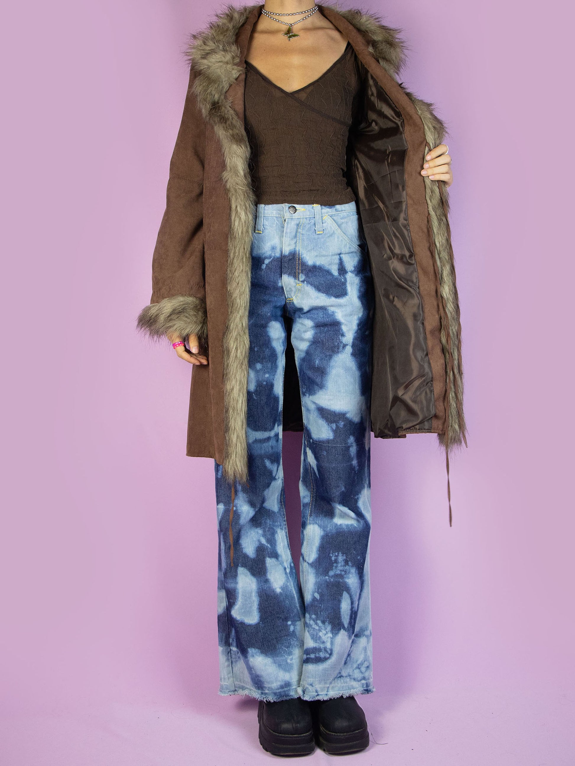 The Y2K Brown Penny Lane Coat is a vintage 2000s afghan-inspired faux suede statement jacket with faux fur collar and cuffs, featuring pockets and a tied front.
