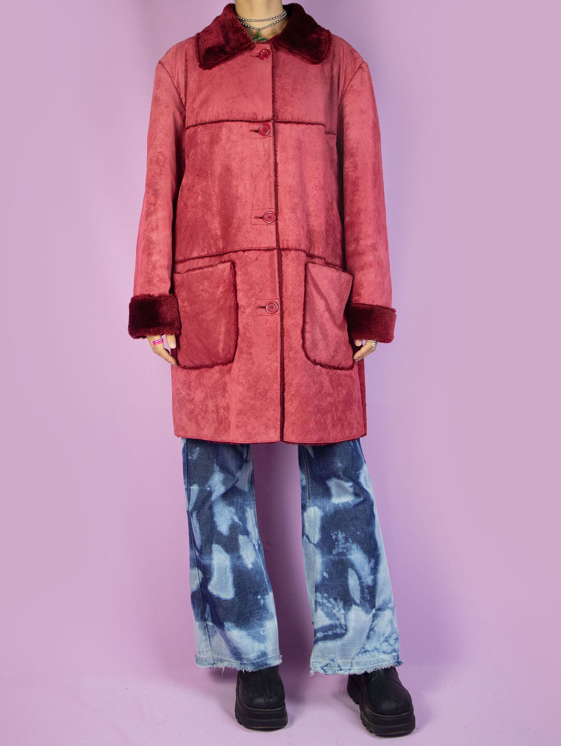 The Y2K Red Faux Fur Coat is a vintage red faux suede coat with faux fur interior, collar, and cuffs, featuring pockets and a button closure. Stunning boho grunge whimsygoth winter statement jacket from the 2000s.