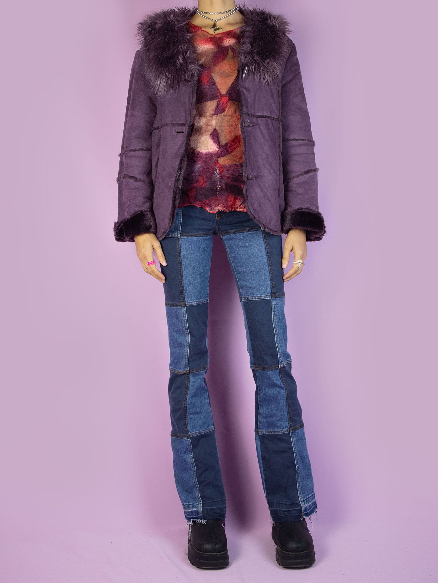 The Y2K Purple Faux Fur Jacket is a vintage purple faux suede jacket with faux fur interior, collar, cuffs, and toggle closure. Iconic cyber 2000s penny lane statement coat.