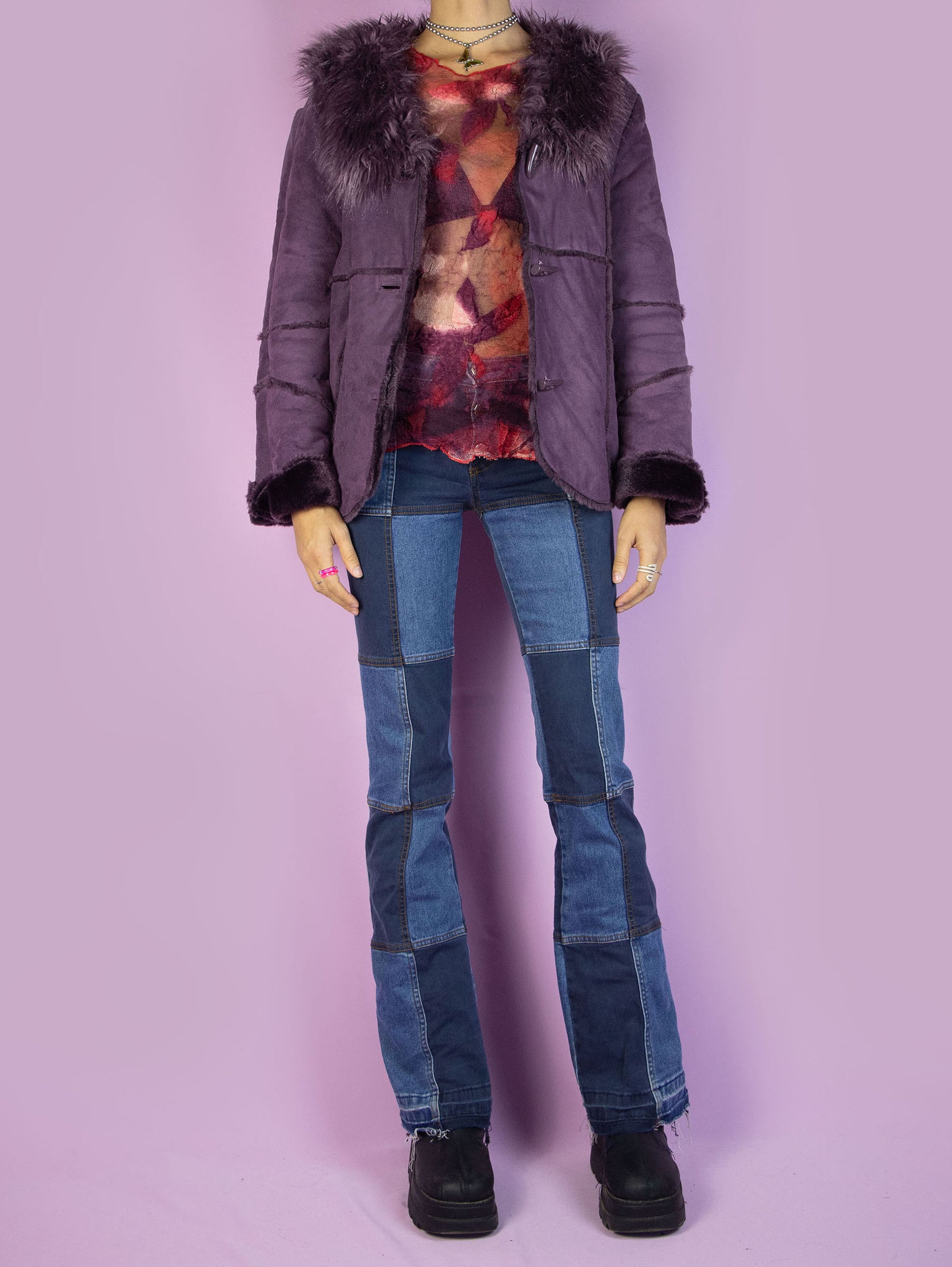 The Y2K Purple Faux Fur Jacket is a vintage purple faux suede jacket with faux fur interior, collar, cuffs, and toggle closure. Iconic cyber 2000s penny lane statement coat.