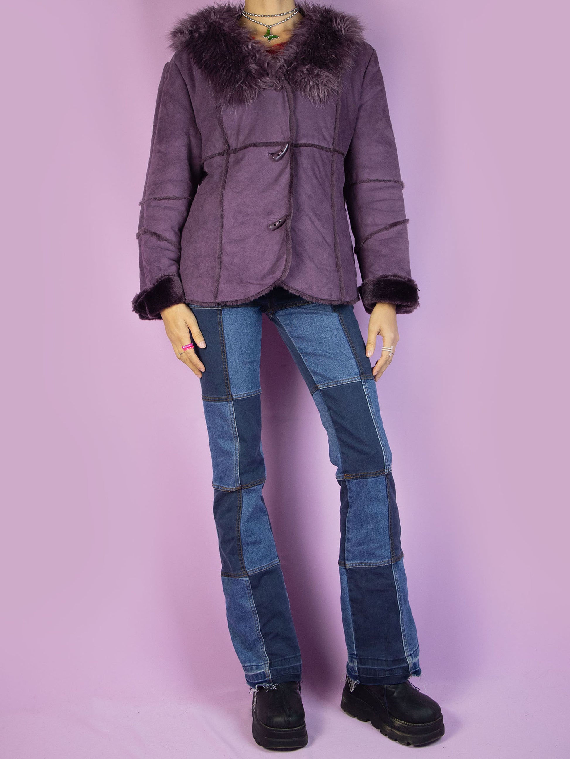 The Y2K Purple Faux Fur Jacket is a vintage purple faux suede jacket with faux fur interior, collar, cuffs, and toggle closure. Iconic cyber 2000s penny lane statement coat.