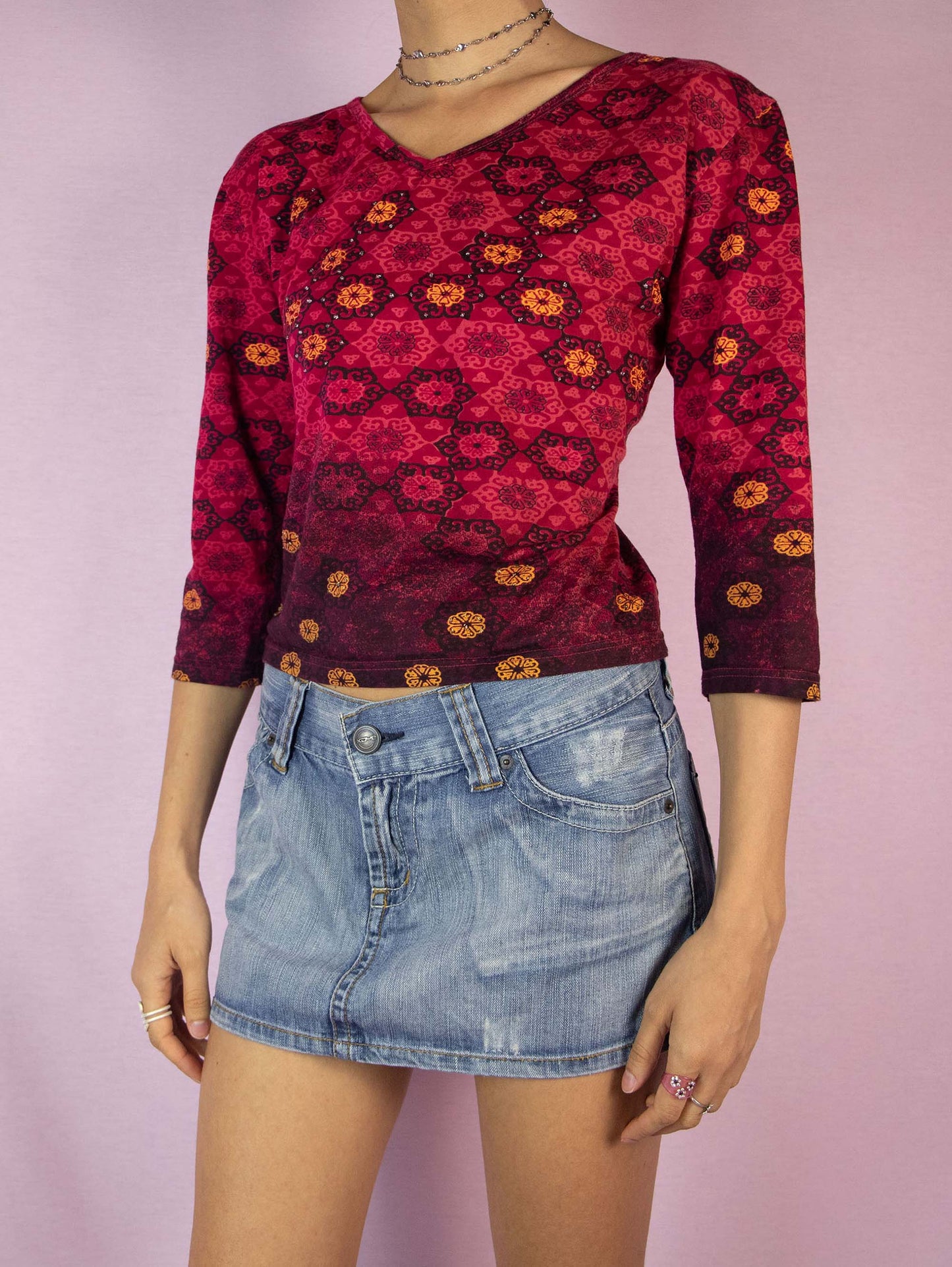 The Y2K Red Abstract Print Top is a vintage 2000s burgundy boho half-sleeve shirt with a graphic pattern and embellished with beads.