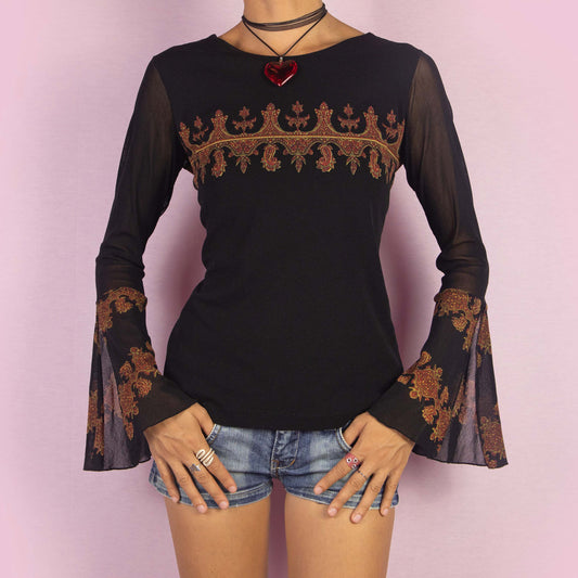 The Y2K Black Mesh Bell Sleeve Top is a vintage 2000s piece featuring a paisley-inspired print with baroque-style elements in warm hues across the chest and bell sleeves. Made from a semi-sheer mesh fabric, this top includes dramatic slit flared sleeves. Perfect for whimsical evening events.