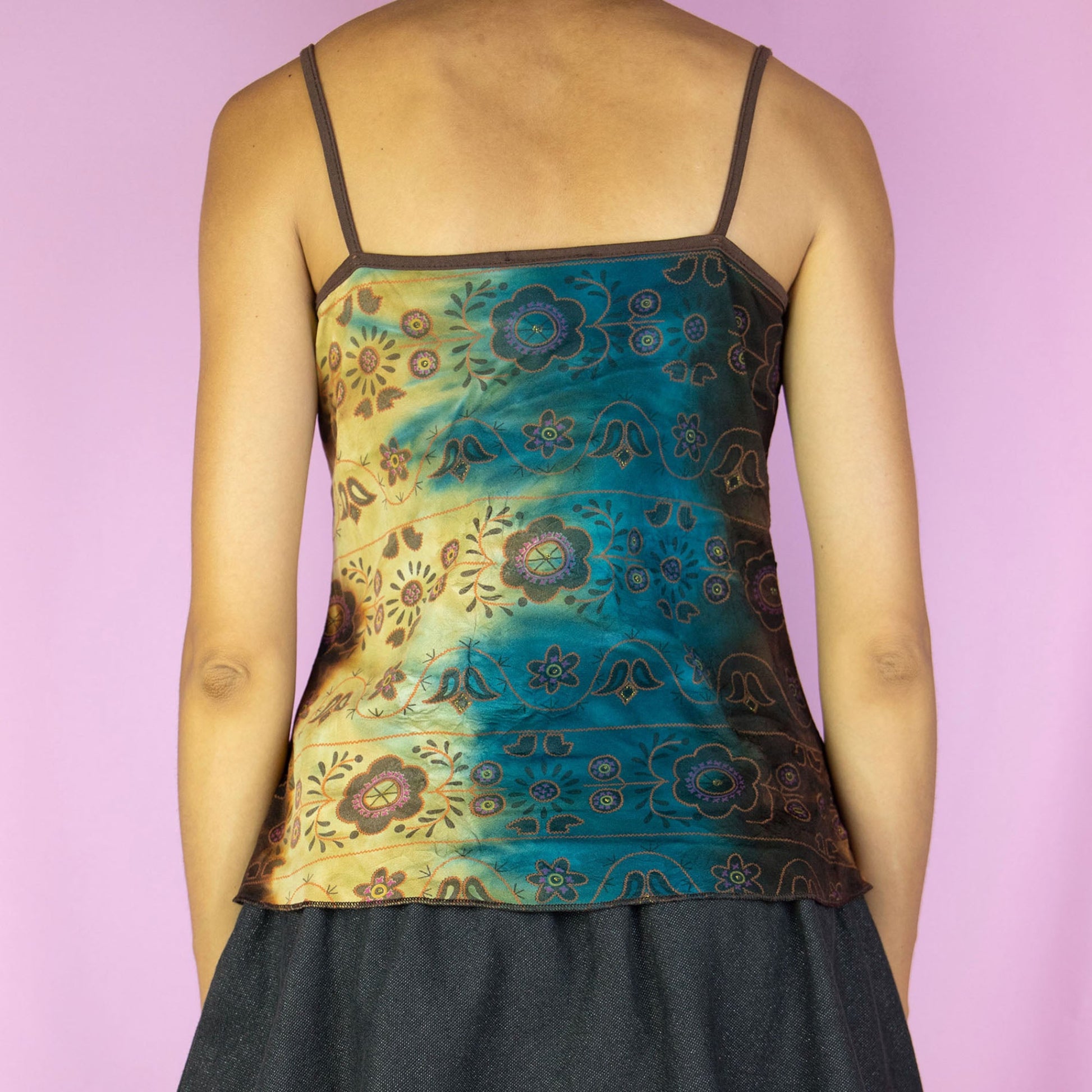 The Y2K Fairy Ruffle Cami Top is a vintage blue and brown multicolored tie-dye floral pattern tank top with a ruffled, ruched front. Boho grunge 2000s summer shirt.