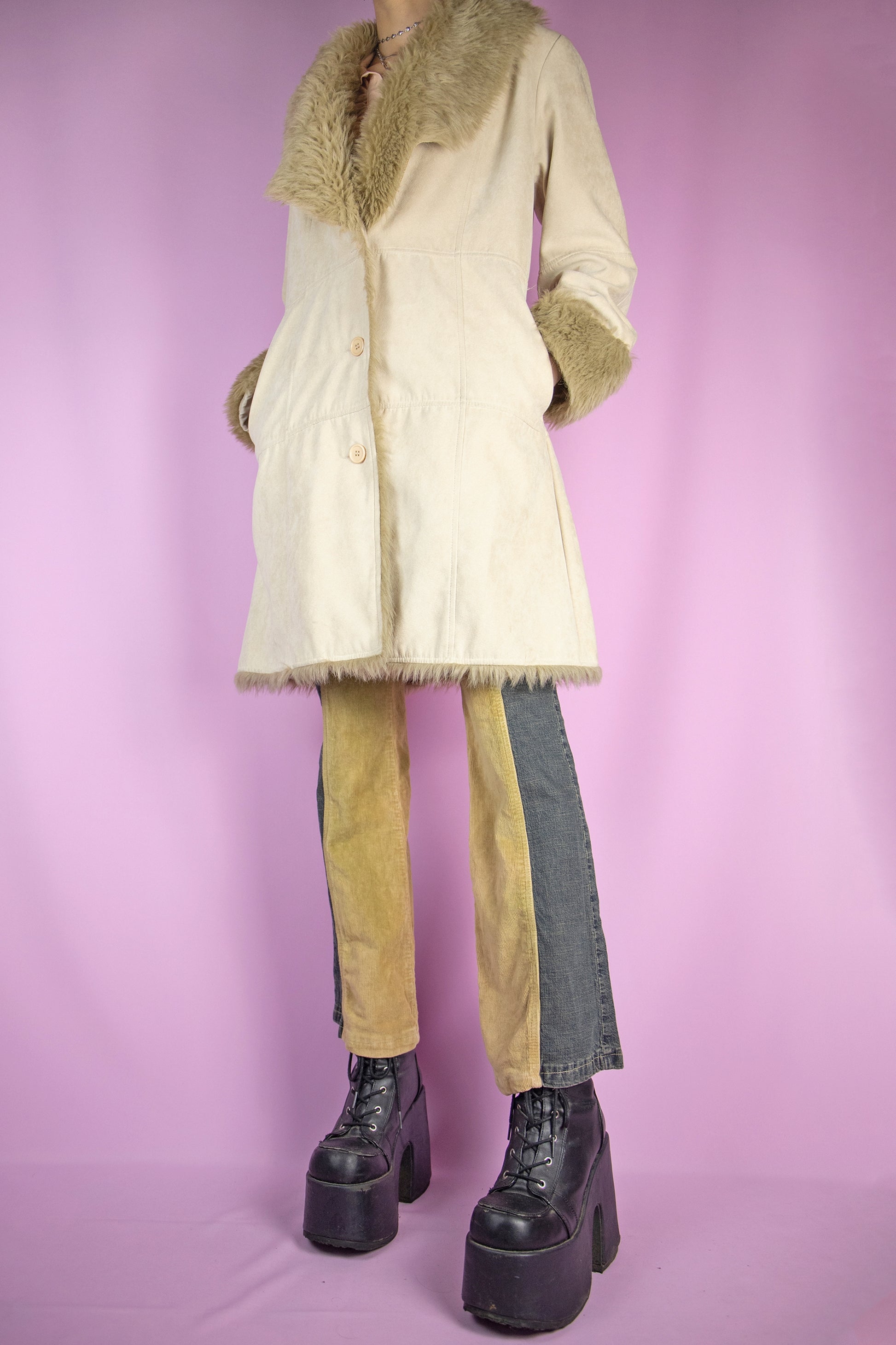 The Y2K Beige Penny Lane Coat is a vintage beige faux suede coat with light brown faux fur collar and cuffs, button closure and pockets. Iconic cyber afghan style 2000s winter statement jacket.