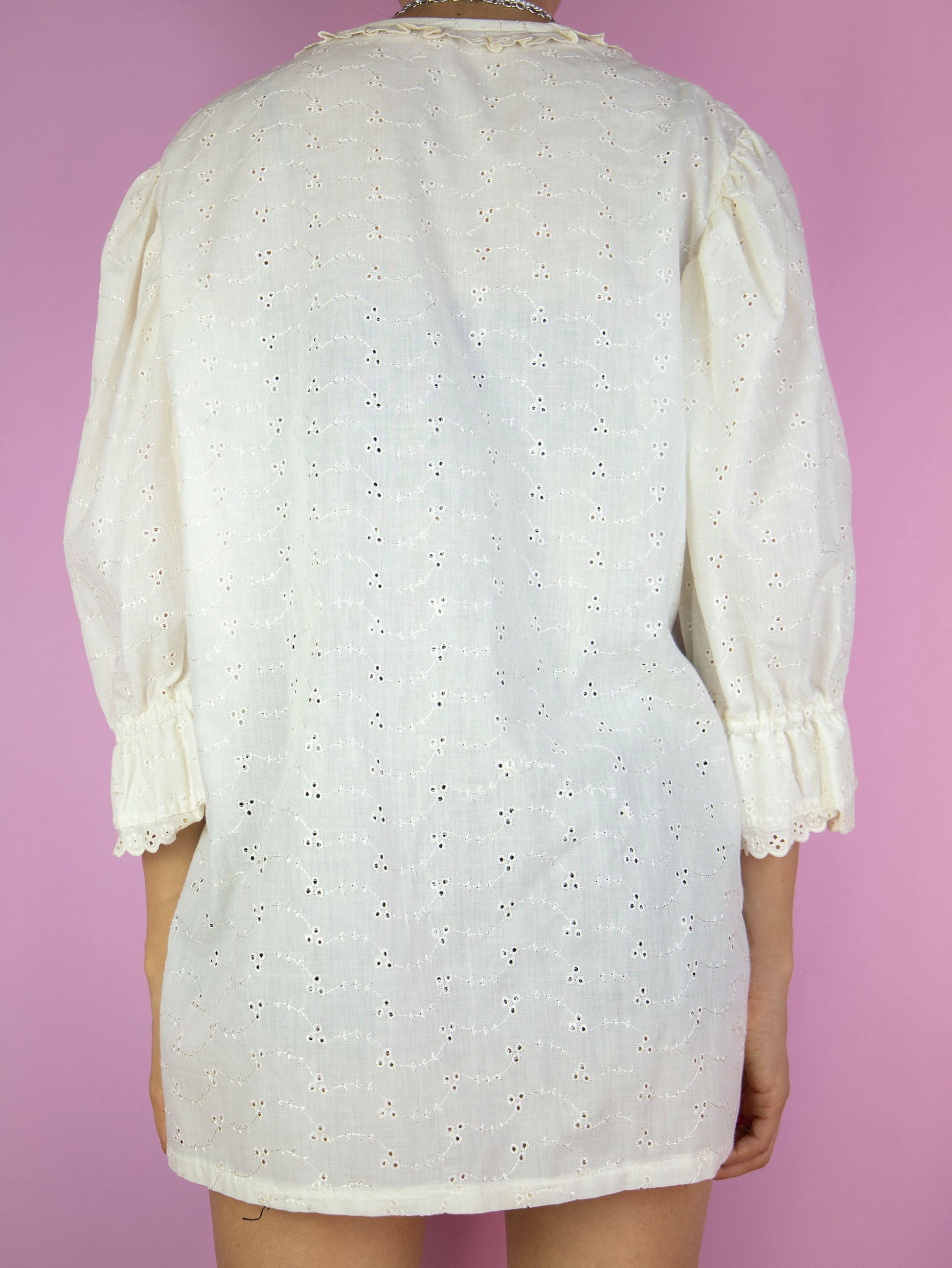 The Vintage 90s Cream White Blouse is a country cottage prairie inspired summer shirt with a ruffled neckline, lace trim and floral embroidery, buttons and puff sleeves.