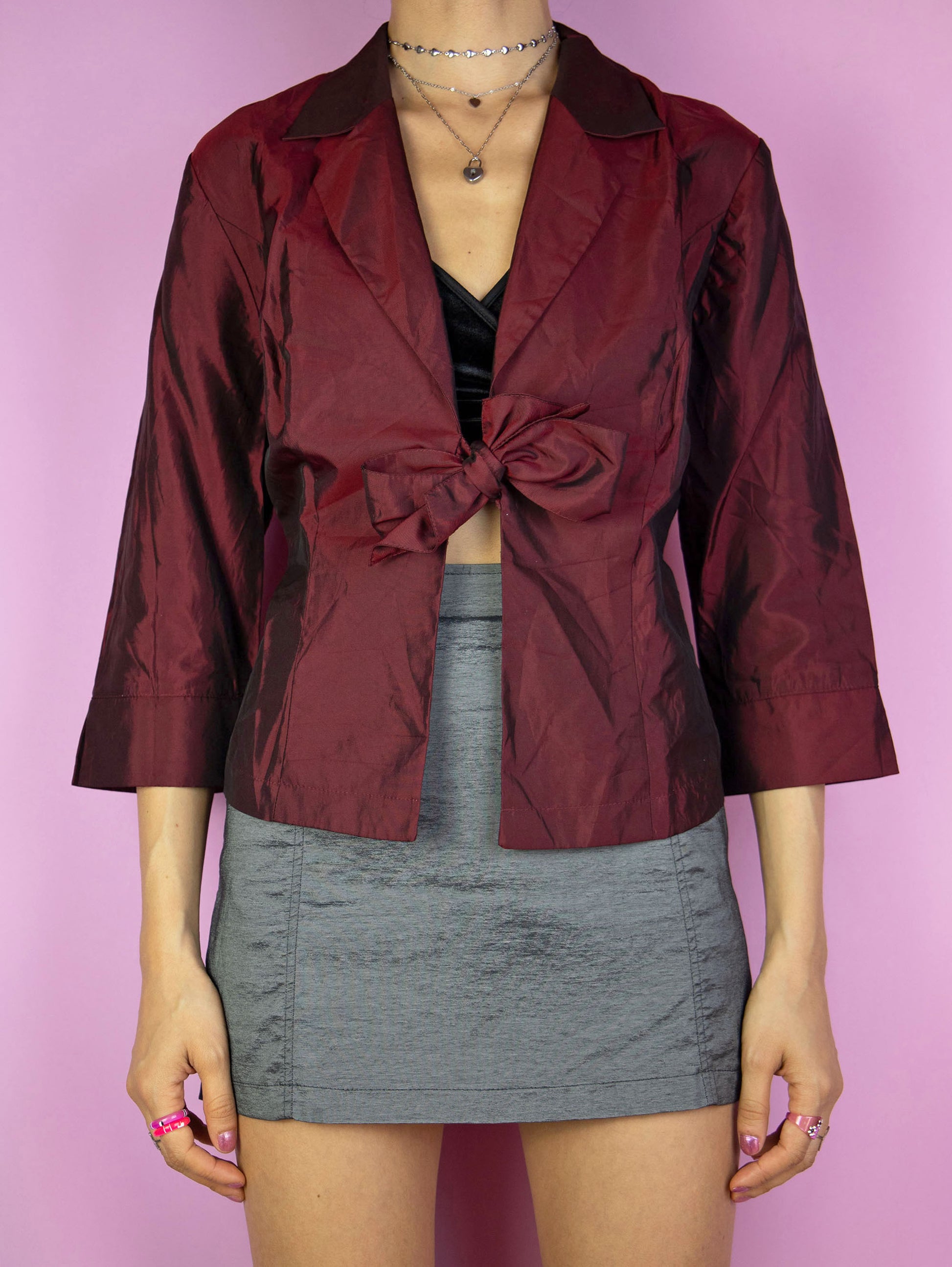 The Y2K Maroon Tie Bolero Jacket is a vintage 2000s elegant party style iridescent shimmering burgundy red half-sleeve top that ties in the front.