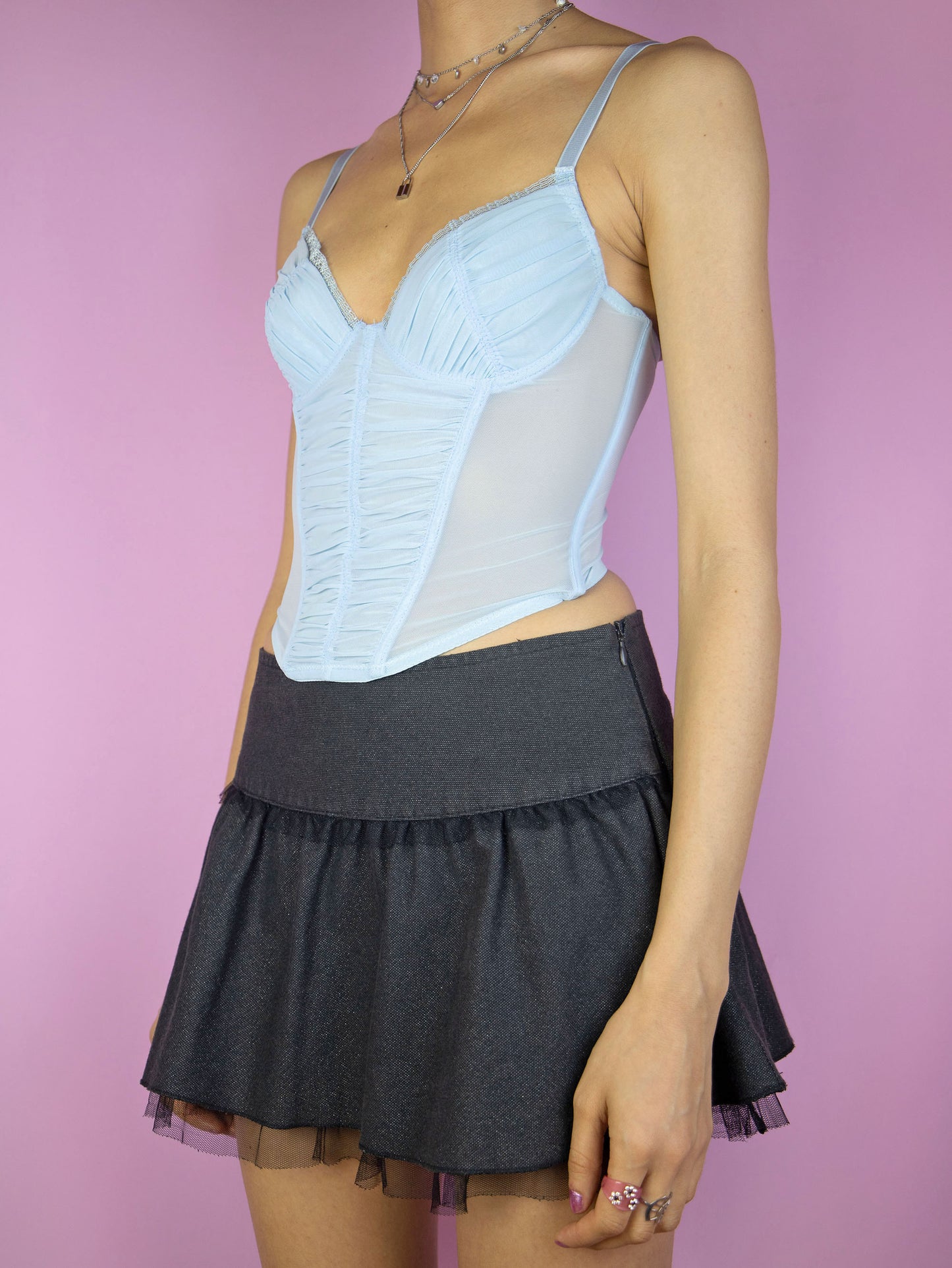 The Y2K Blue Mesh Corset Top is a vintage 2000s romantic coquette pastel light blue semi-sheer ruched lingerie bustier with adjustable straps and back hook closure.