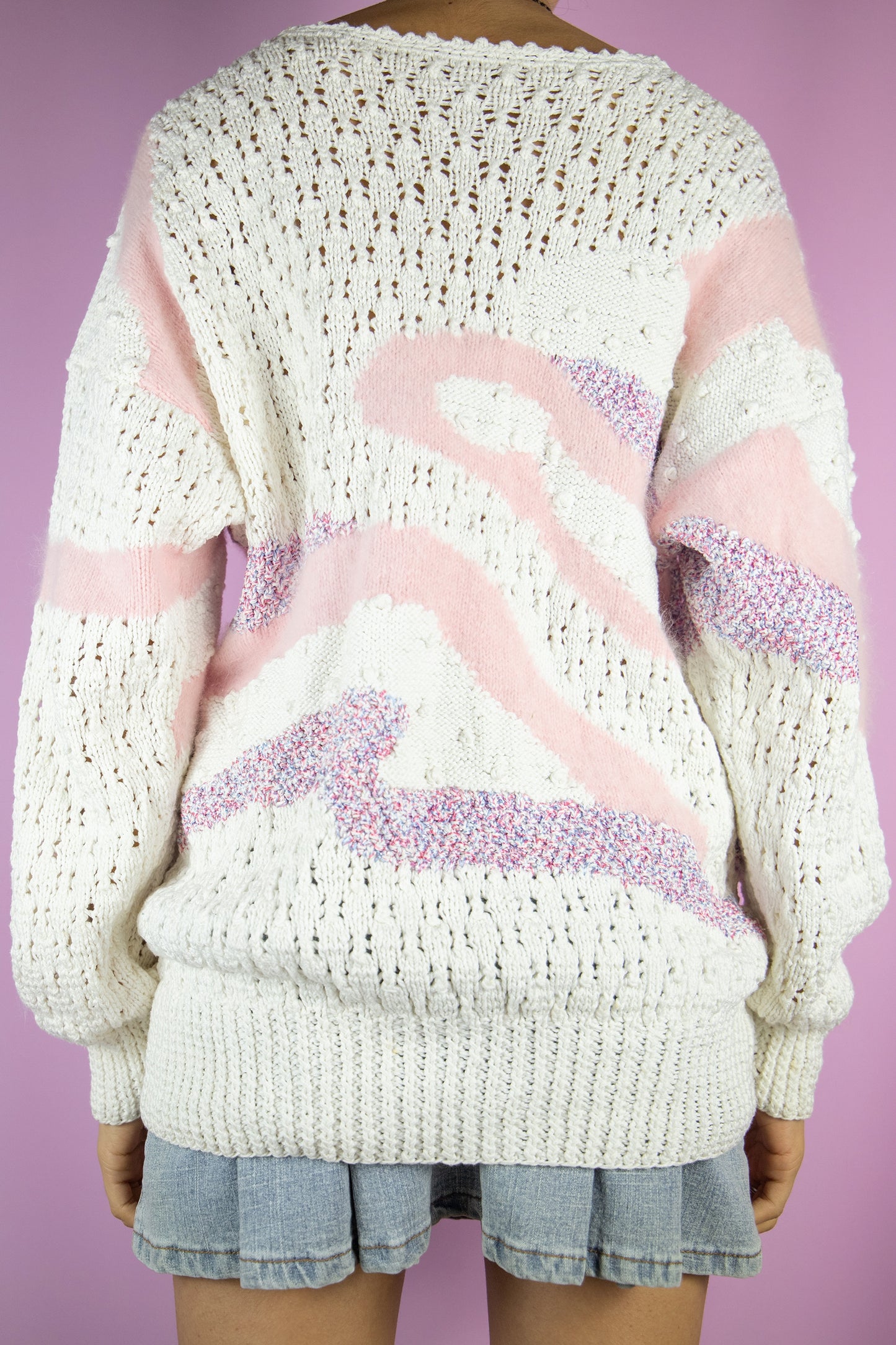 The Vintage 80s Retro White Knit Sweater is a knitted white sweater with an abstract pattern and pink, red and blue details. Romantic boho 1980s pastel pullover.