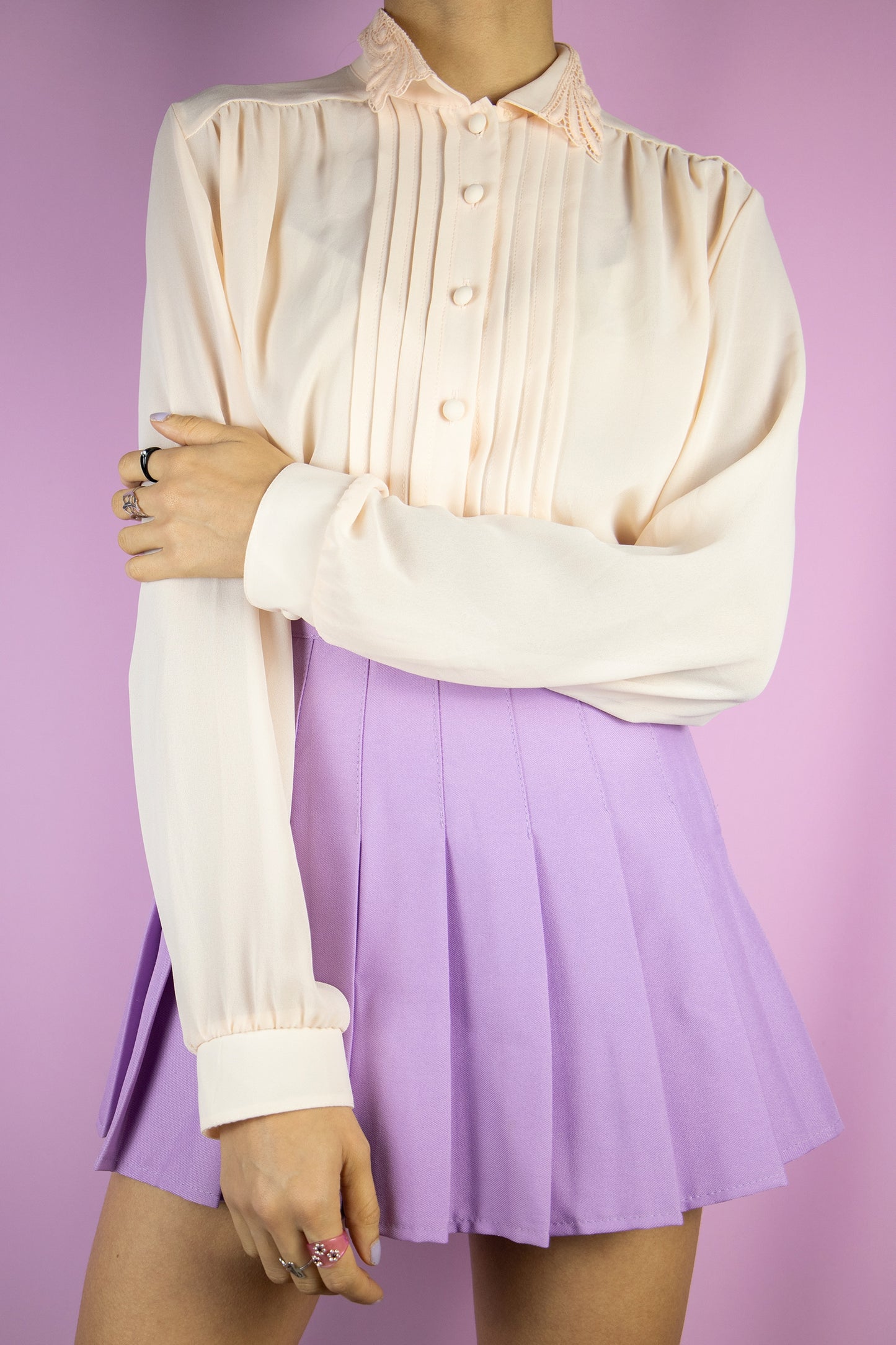 The Vintage 80s Light Pink Romantic Blouse is a semi sheer light pastel pink shirt with pleated front, collar and buttons. Preppy retro 1980s blouse.