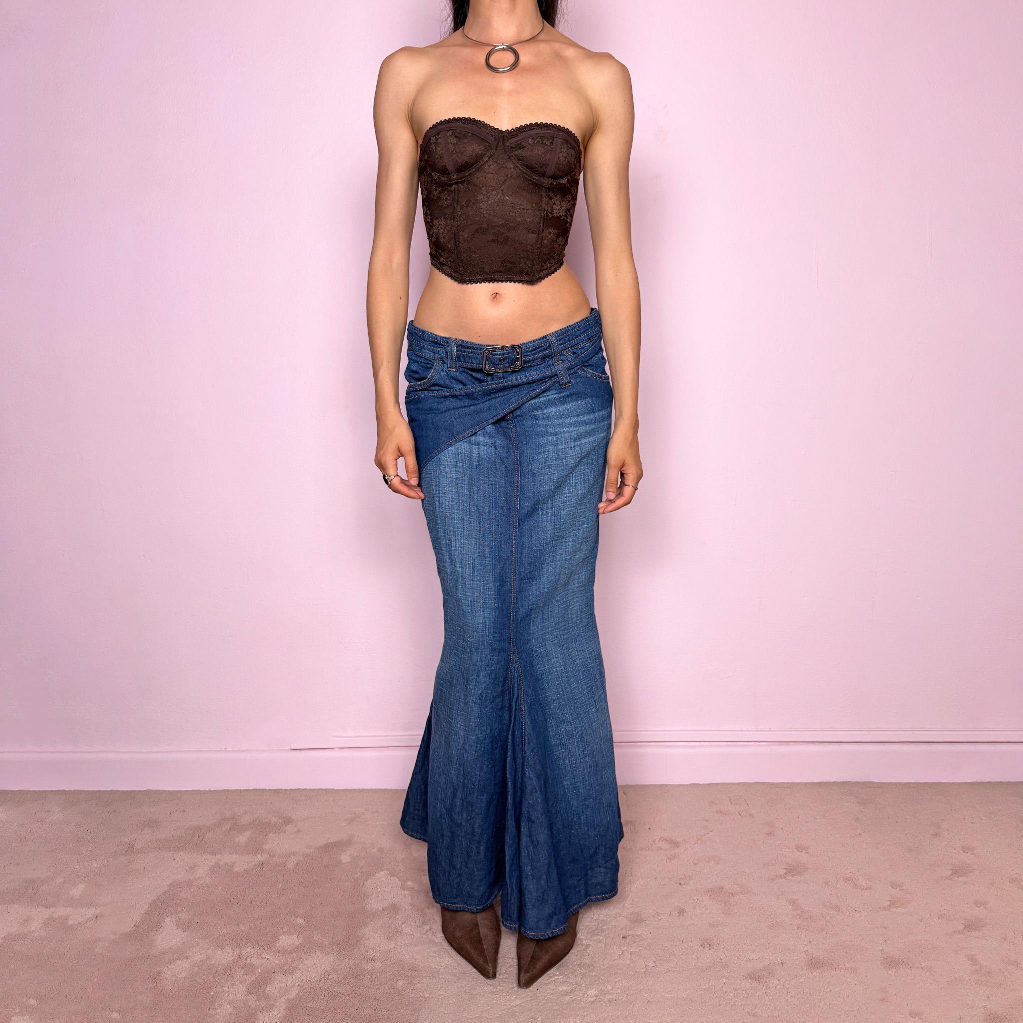 Vintage 2000s Jean’s Paul Gaultier blue denim mermaid maxi skirt made in Italy from a 68% cotton and 32% linen blend. Features a low rise, asymmetric belt detail, front zip closure, belt loops, and a dramatic flared mermaid godet-style hem. Designed with no stretch for a sculpted silhouette. A rare Y2K designer piece. Excellent vintage condition.