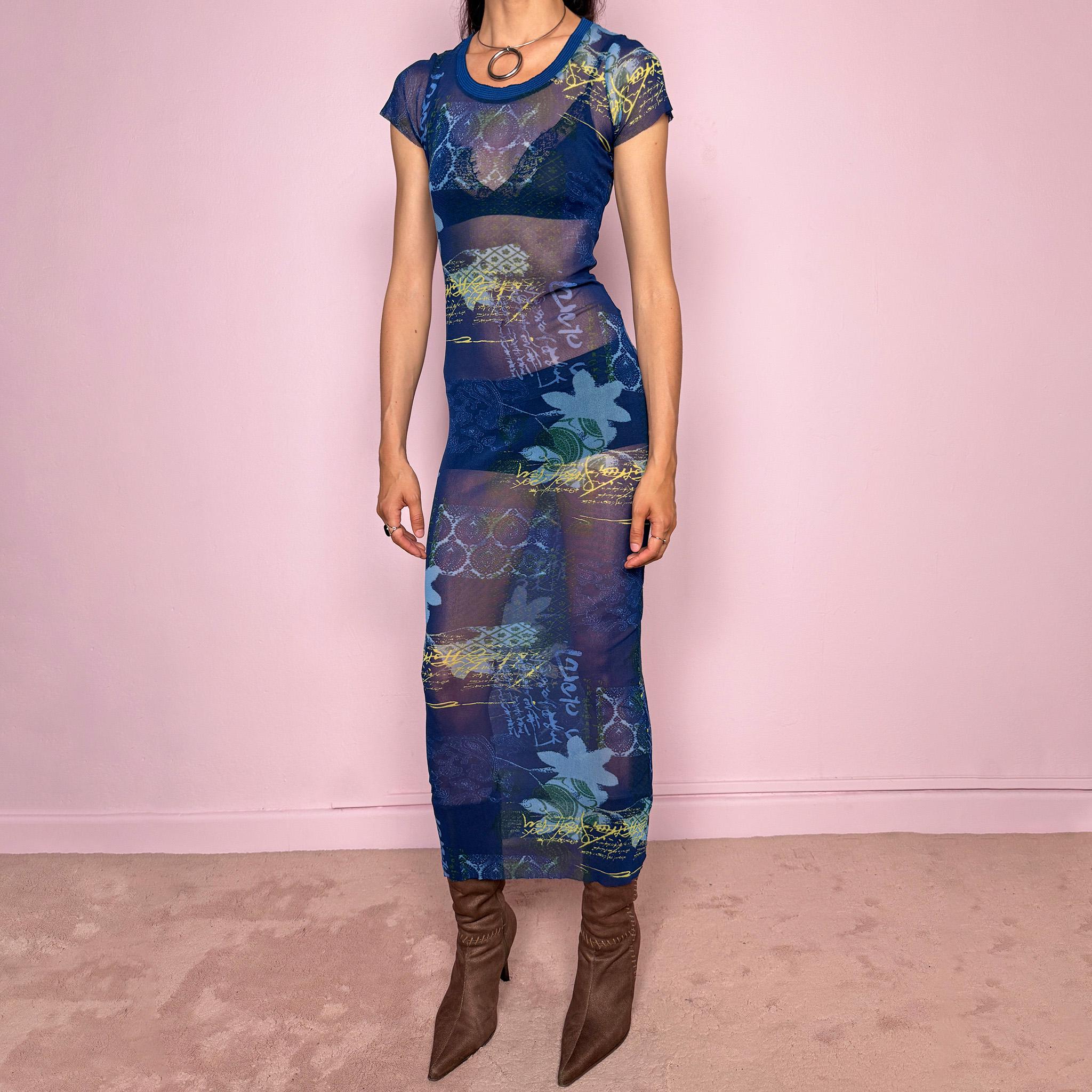 Vintage 2000s Kenzo Jeans sheer mesh maxi dress in a striking dark blue abstract patchwork print with floral and graphic details throughout. Designed in a fitted long silhouette with short sleeves, a round neckline, and lightweight semi-sheer fabric. A bold 90s/early Y2K designer piece with a futuristic avant-garde aesthetic, perfect for an editorial look.