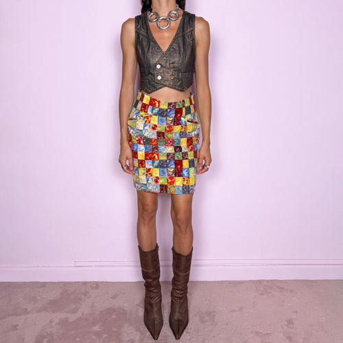 Vintage 80s colorful wool mini skirt by Kenzo Paris, made in France from 100% wool with a 60% acetate and 40% viscose lining. Featuring a high-waisted, fitted silhouette, a bold multicolor square print in red, yellow, blue, and green tones, and a back zip closure. Non-stretch. The vibrant geometric print and structured wool construction give it a playful, maximalist Kenzo Takada-era aesthetic. Excellent vintage condition.