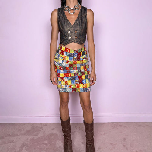 Vintage 80s colorful wool mini skirt by Kenzo Paris, made in France from 100% wool with a 60% acetate and 40% viscose lining. Featuring a high-waisted, fitted silhouette, a bold multicolor square print in red, yellow, blue, and green tones, and a back zip closure. Non-stretch. The vibrant geometric print and structured wool construction give it a playful, maximalist Kenzo Takada-era aesthetic. Excellent vintage condition.