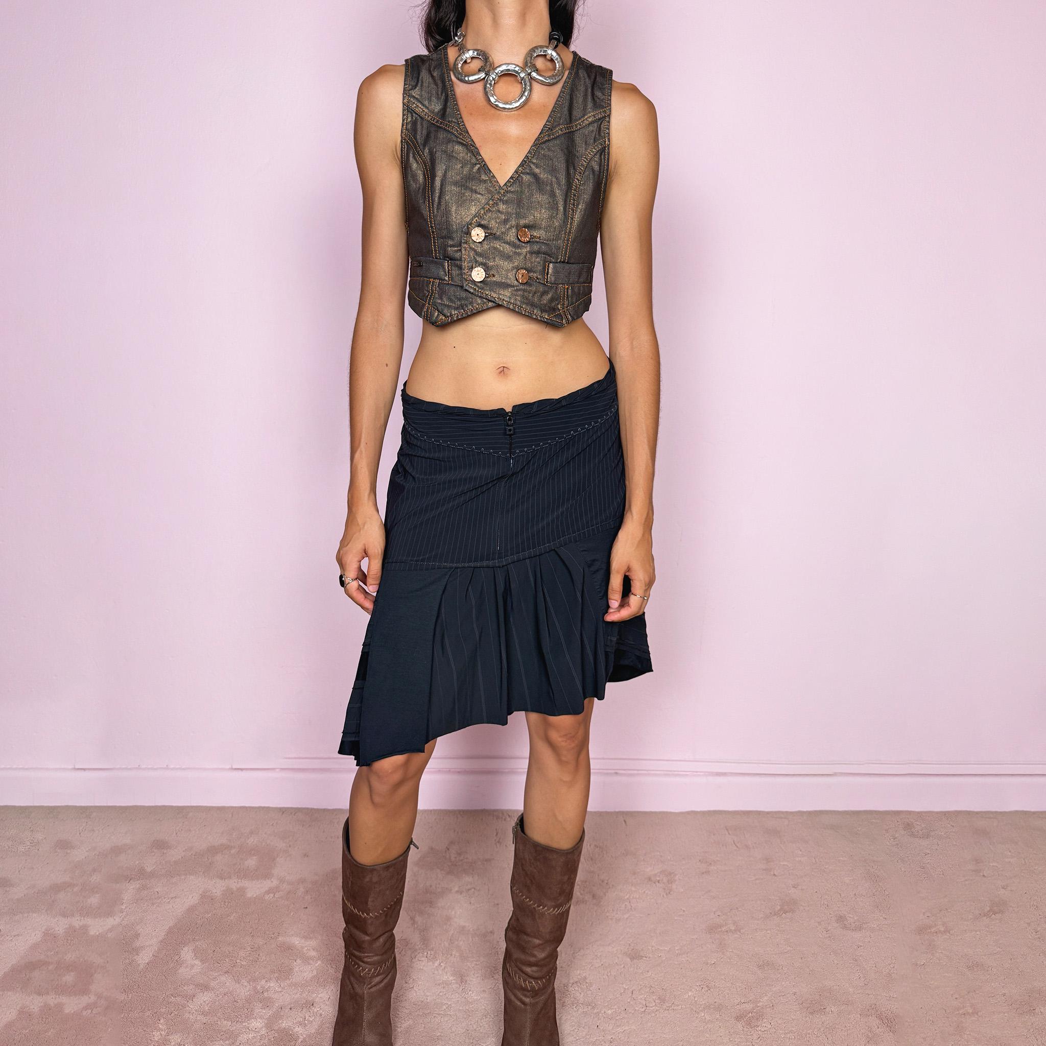 Vintage 2000s Marithé + François Girbaud asymmetric skirt in black and deep navy, featuring a deconstructed patchwork construction that combines fine pinstripes with contrasting smooth panels, a front zip closure, curved seam detailing, and softly pleated sections that create volume and irregular movement through the hem. Can be worn high-waisted for size M or lower-rise for size S. Made from a stretchy polyamide, elastane, and cotton blend. Excellent vintage condition.