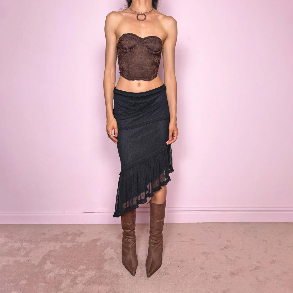 Vintage 2000s Moschino Jeans black lace asymmetric midi skirt made in Italy from a stretchy polyamide fabric. Features a low-rise, soft stretch waistband without elastic, delicate ruffle trim, layered asymmetric panels, and a sheer lace pleated hem. A dark romantic Y2K designer piece, perfect for elevated evening looks. Excellent vintage condition.