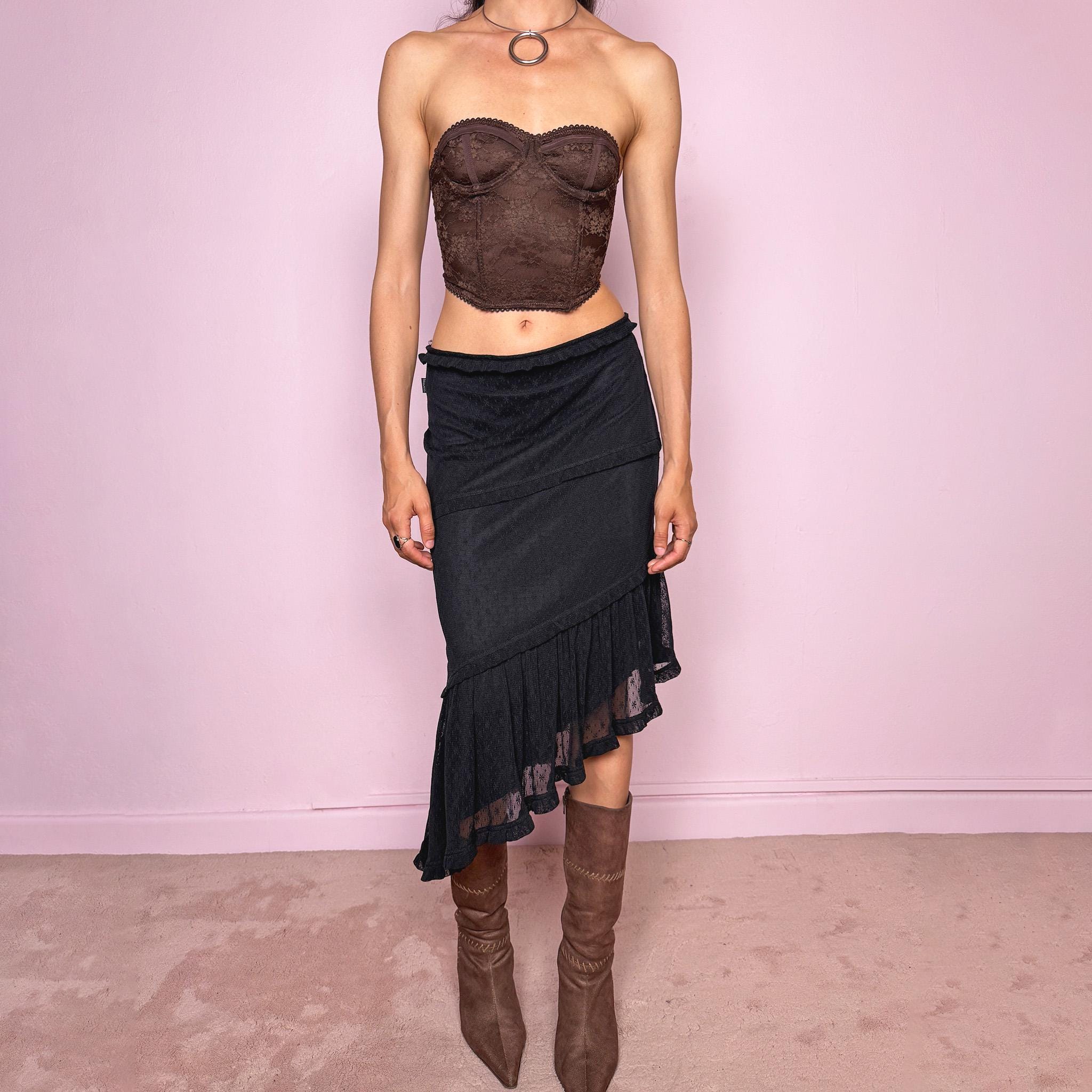 Vintage 2000s Moschino Jeans black lace asymmetric midi skirt made in Italy from a stretchy polyamide fabric. Features a low-rise, soft stretch waistband without elastic, delicate ruffle trim, layered asymmetric panels, and a sheer lace pleated hem. A dark romantic Y2K designer piece, perfect for elevated evening looks. Excellent vintage condition.